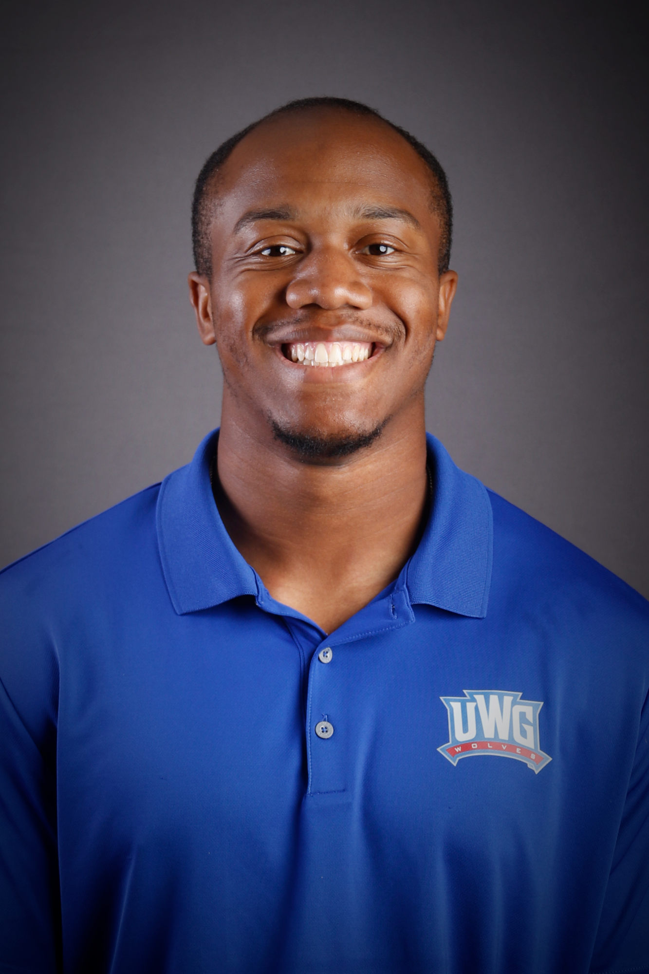 Headshot of Football coach in Blue Polo
