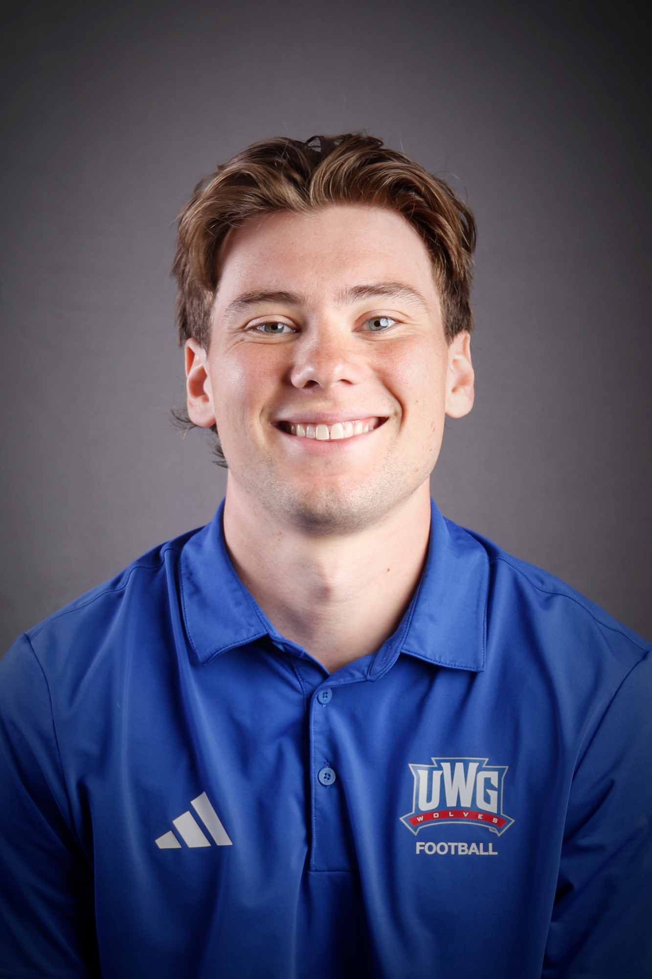 Headshot of Football coach in Blue Polo