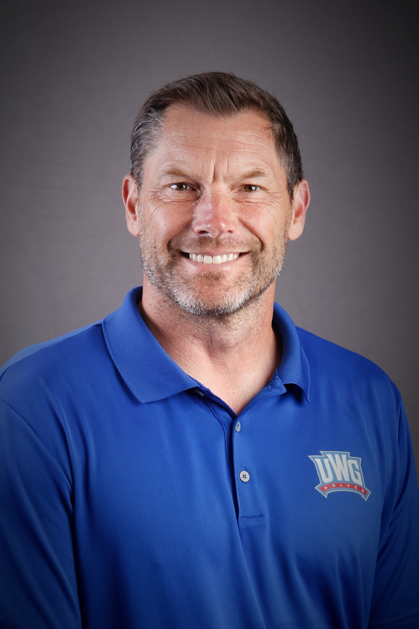 Headshot of Football coach in Blue Polo