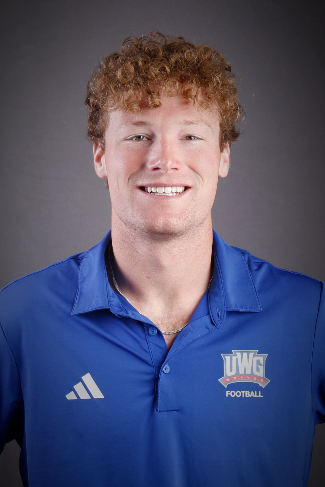 Headshot of Football coach in Blue Polo