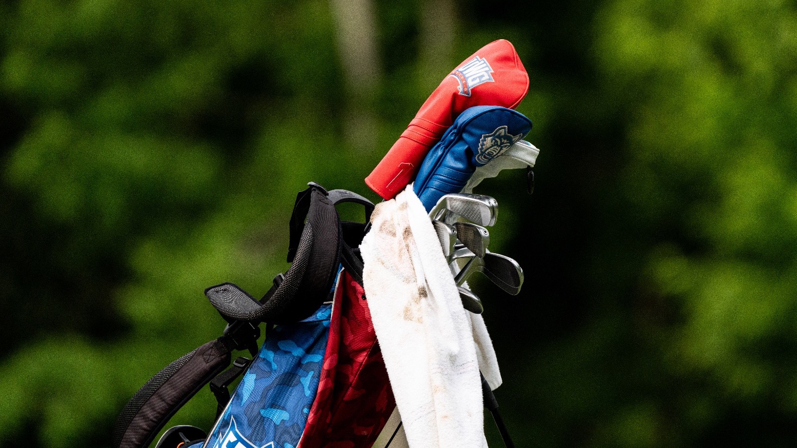 A photo of a UWG men's golf bag with head covers and a towel.