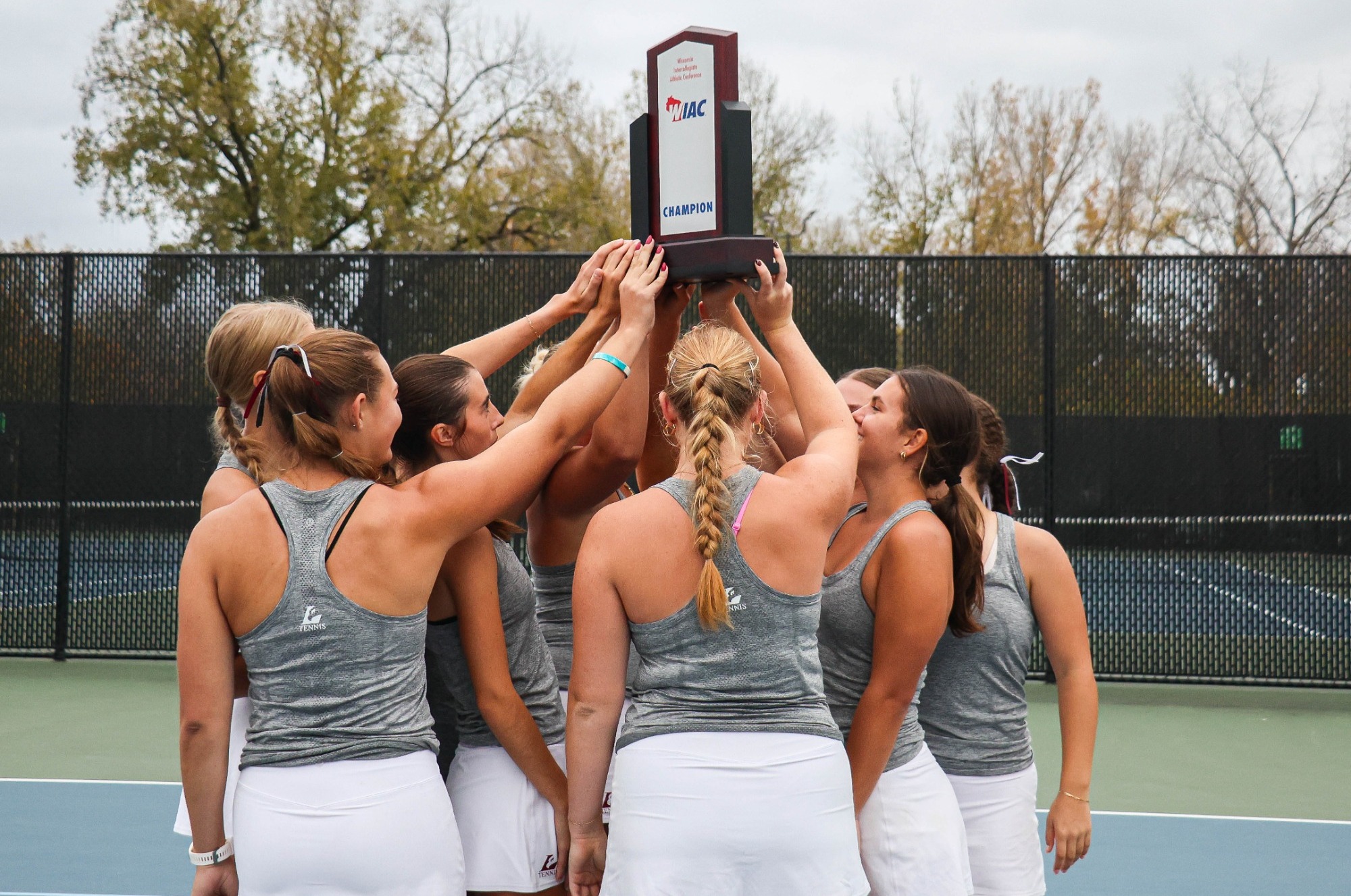 Women's Tennis Team Holding WIAC Trophy