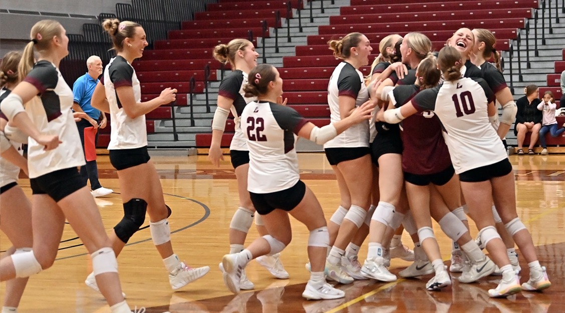 Action photo of volleyball team celebrating