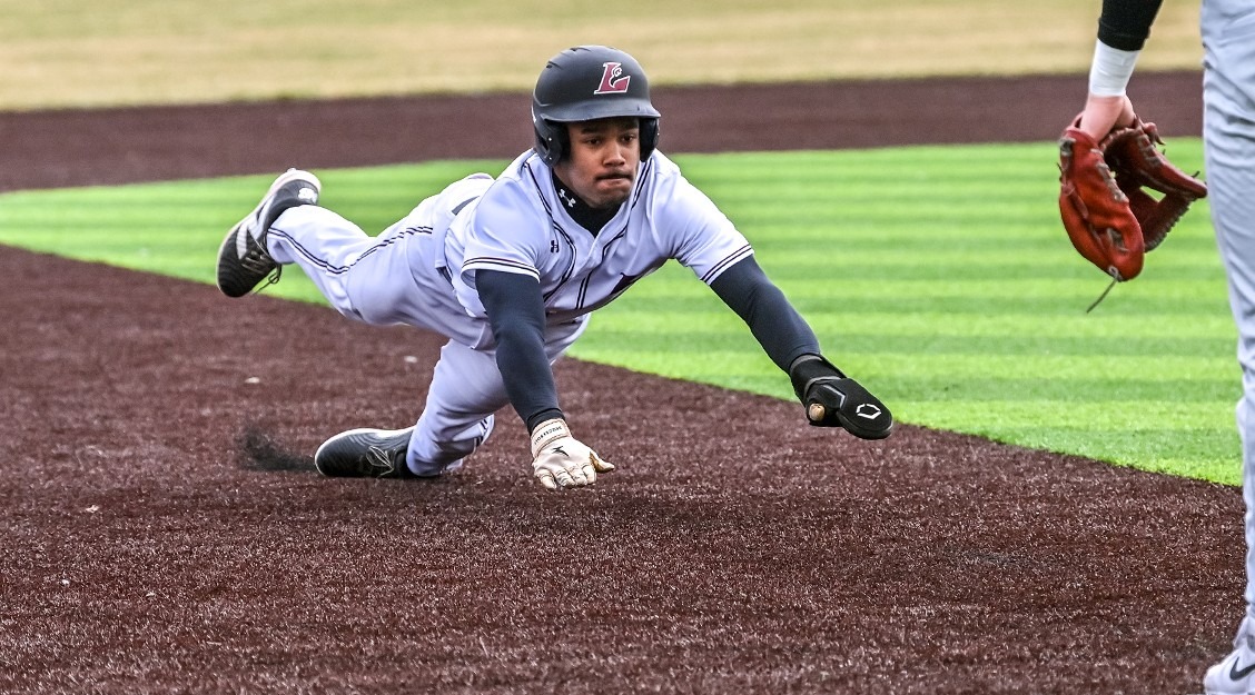Chris Calico sliding head first into third base.