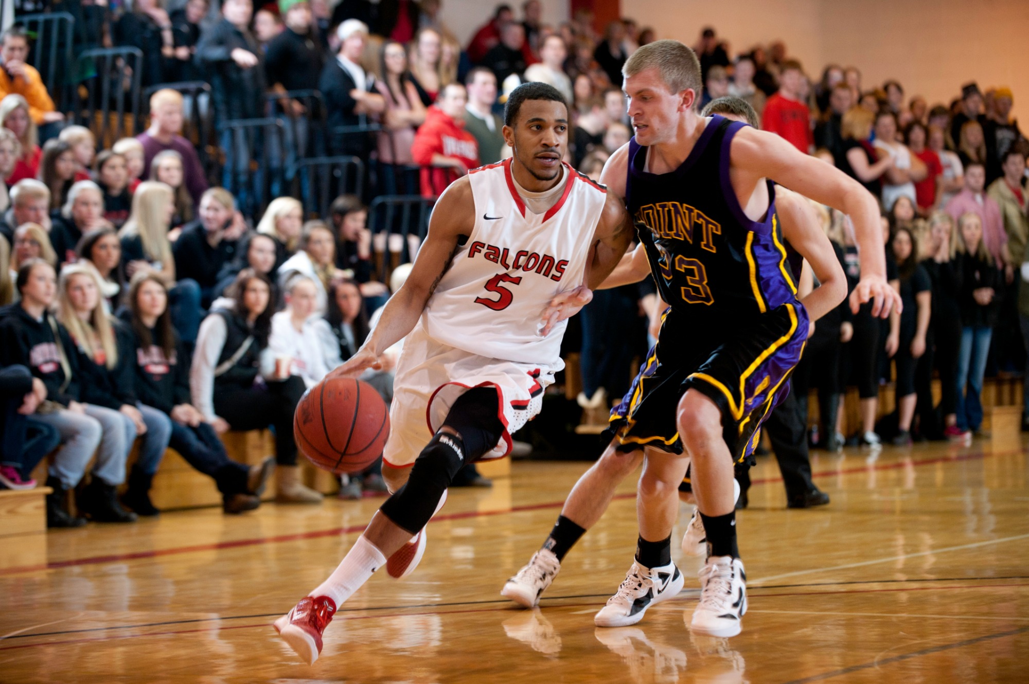 No 5 Brian Kimble maneuvers around a UW Stevens Point player in the second half. The UW-River Falls Men's basketball team defeated UW-Stevens Point  in the WIAC semi-finals 76-51 in the Karges Center Friday February 24, 2012, to advance to the WIAC Championship game Sunday at UW-Whitewater. ..Kathy M Helgeson/staff
