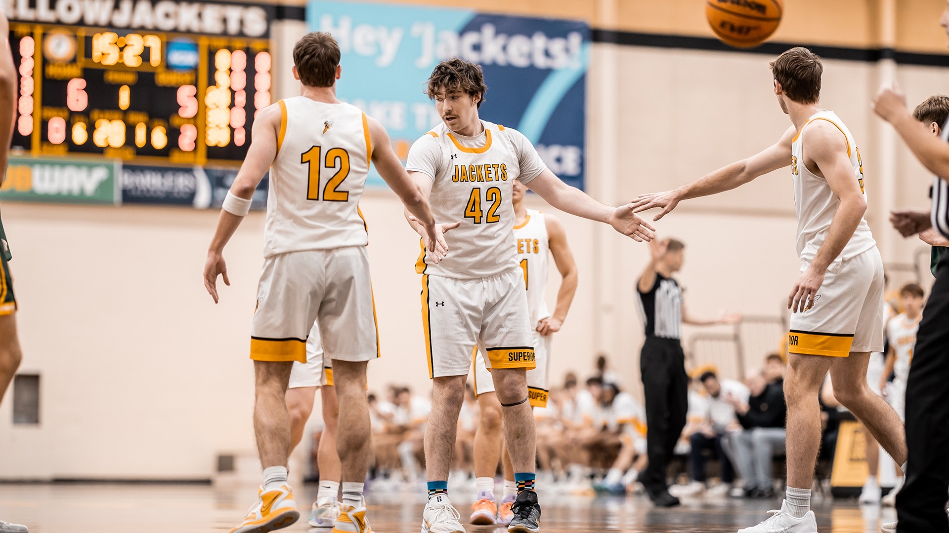 Rocco Paulson high fives teammates after free throw. 