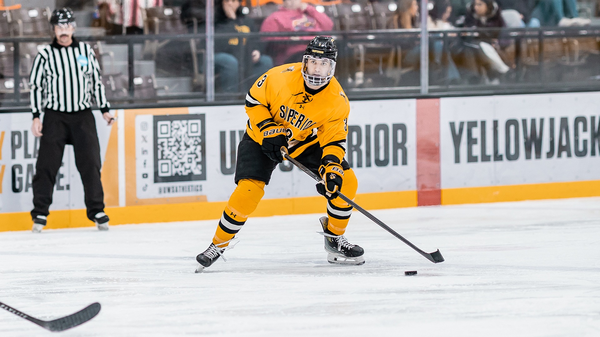 Tyler Ryder skates with puck in game against UW-River Falls.