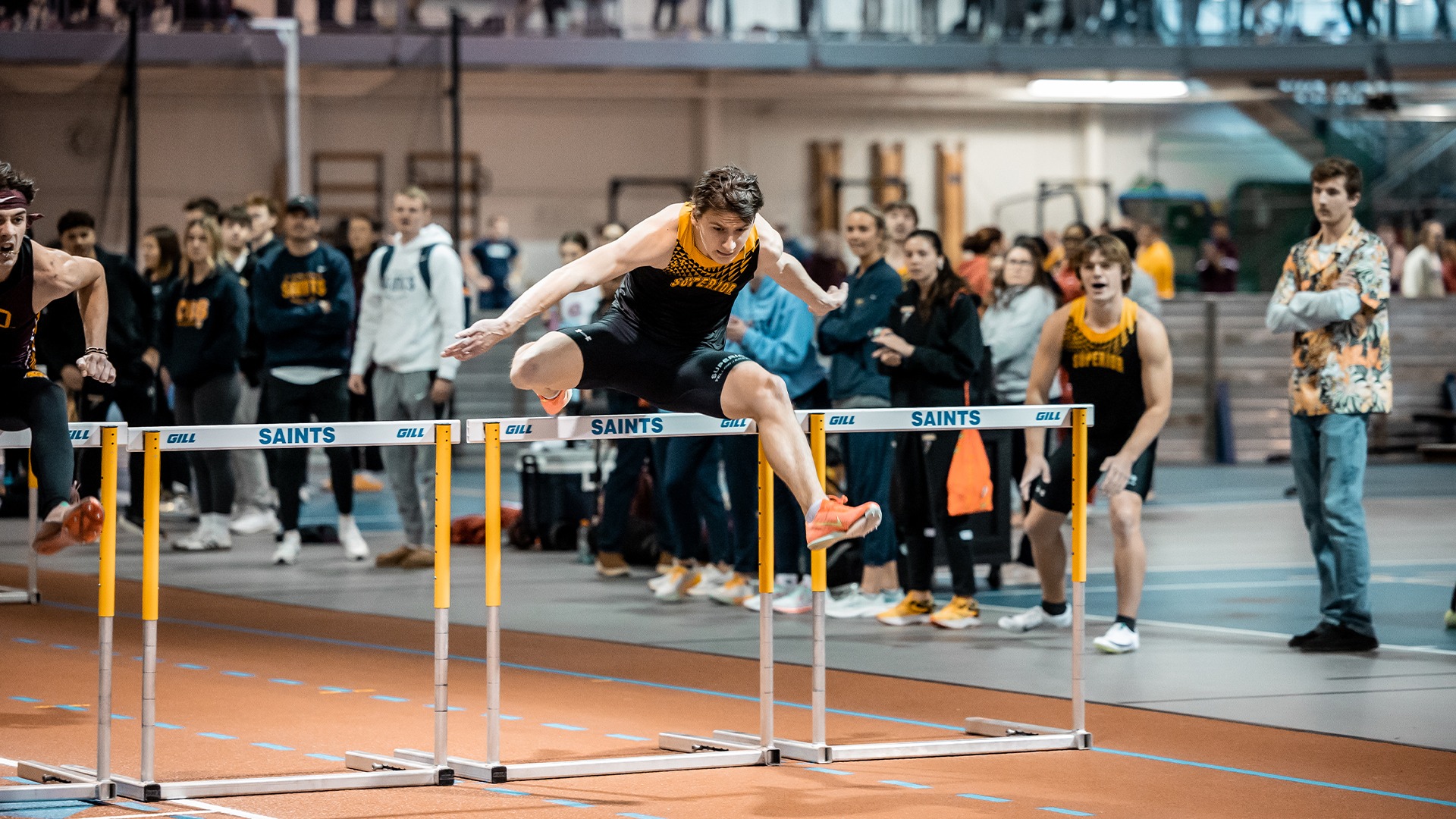 Kyle Peterson leaping over a hurdle.