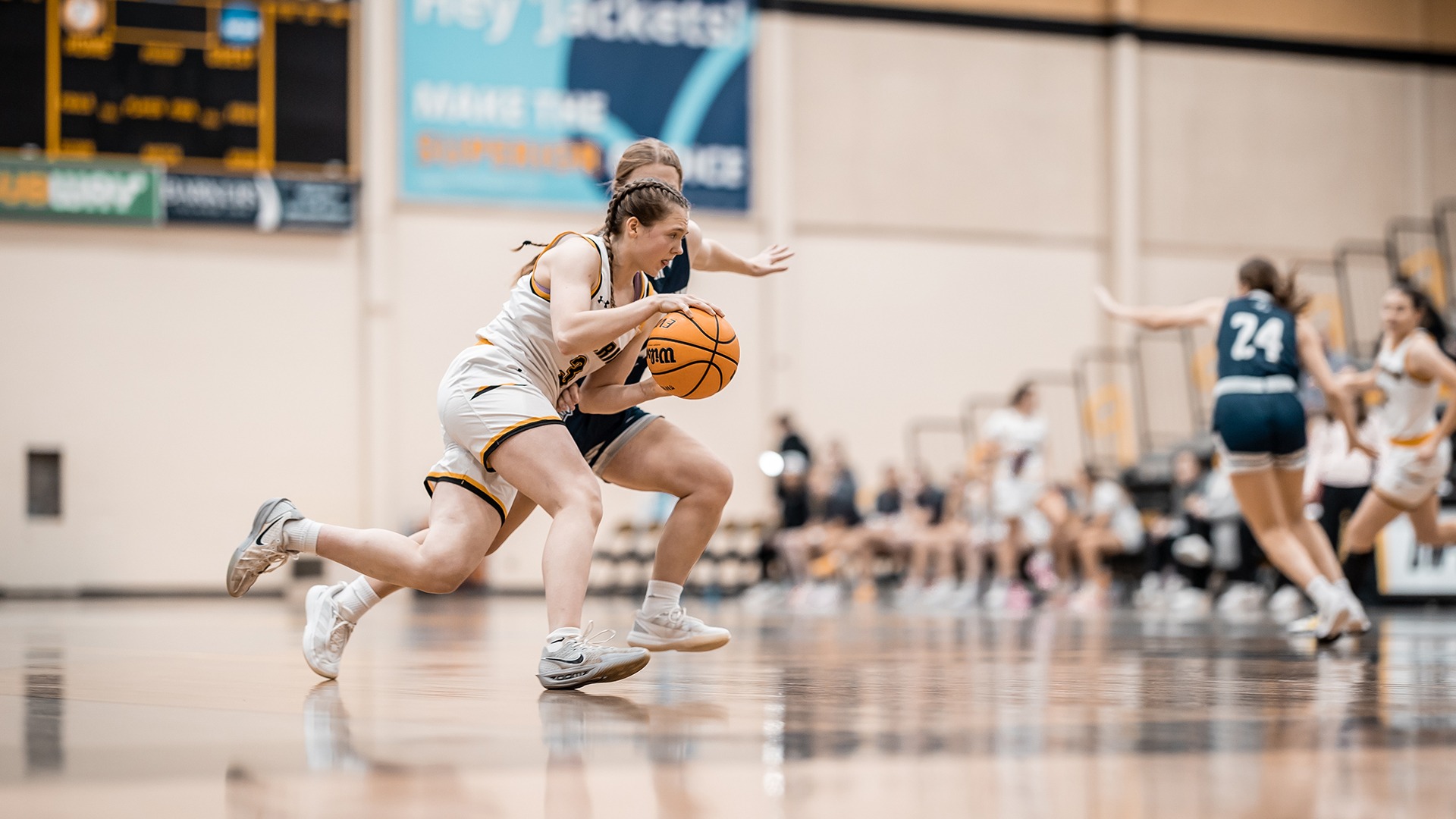 Maddie Reott drives to hoop against UW-Stout defender. 
