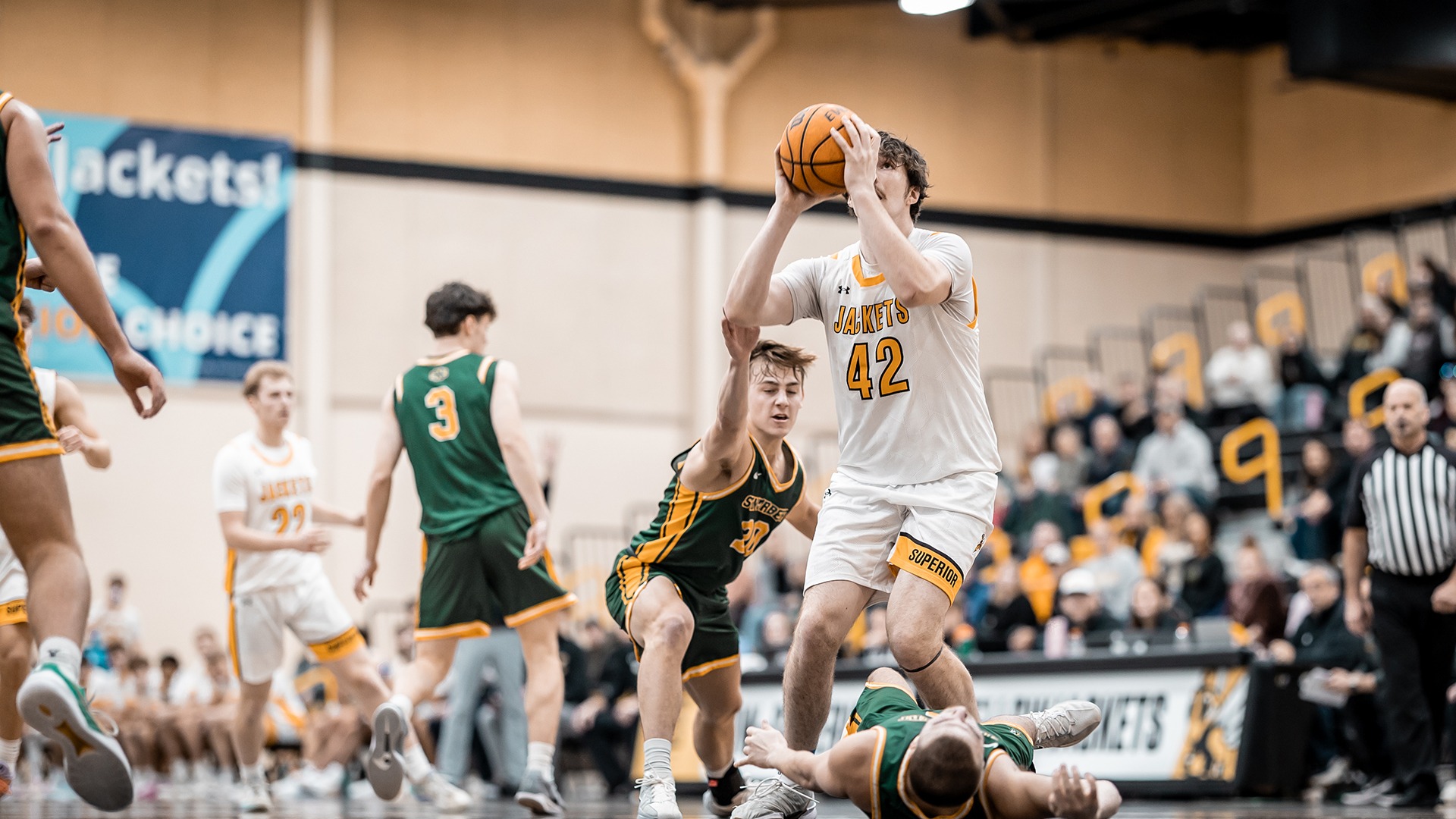 Rocco Paulson drops Green Knights defender on way to hoop. 