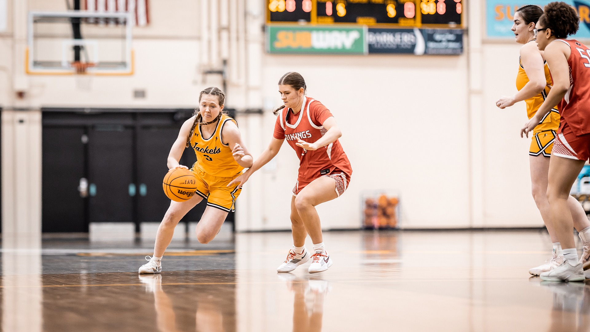 Maddie Reott dribbling past a Viking defender.