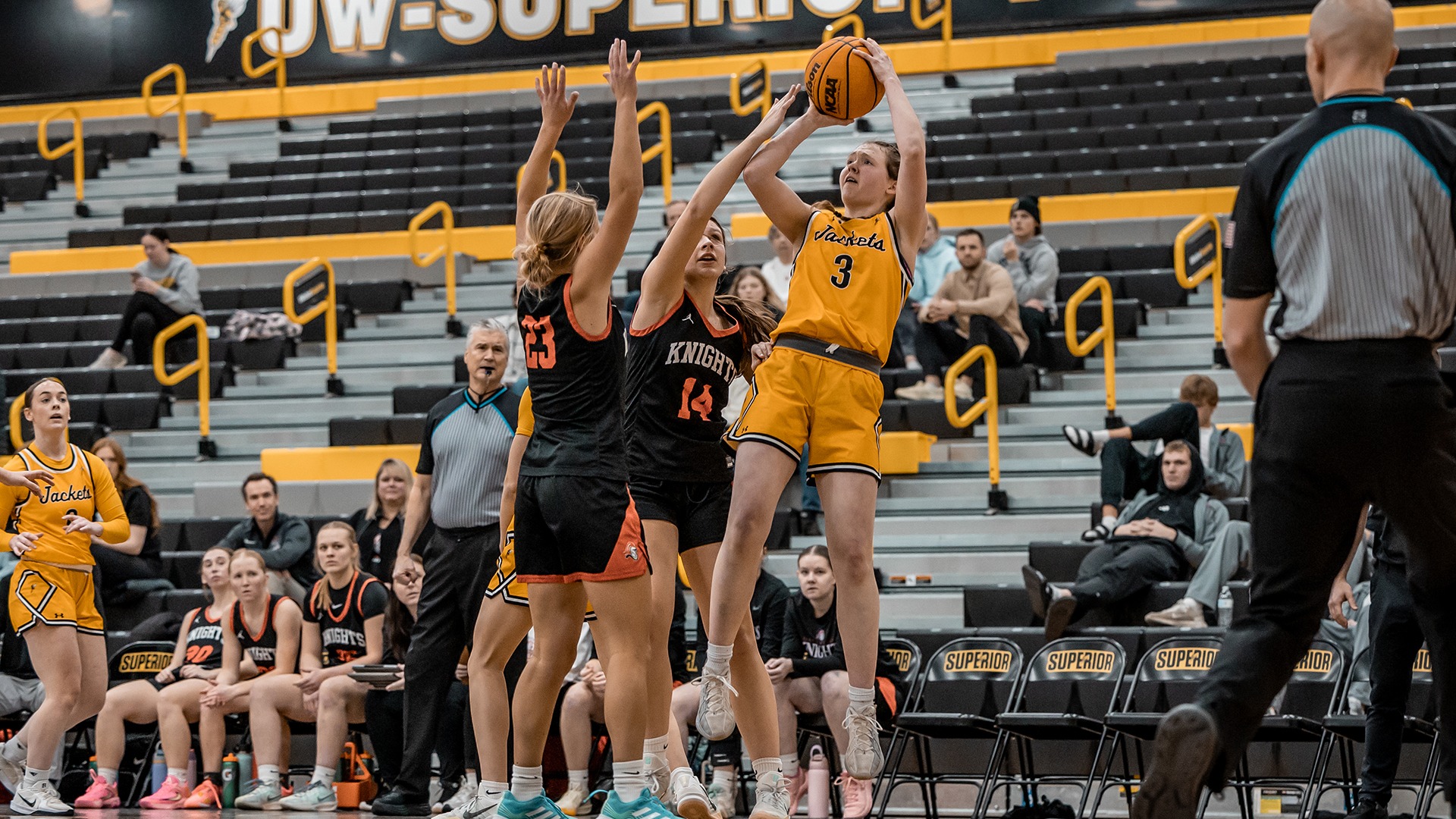 Maddie Reott shoots over two Martin Luther defenders. 