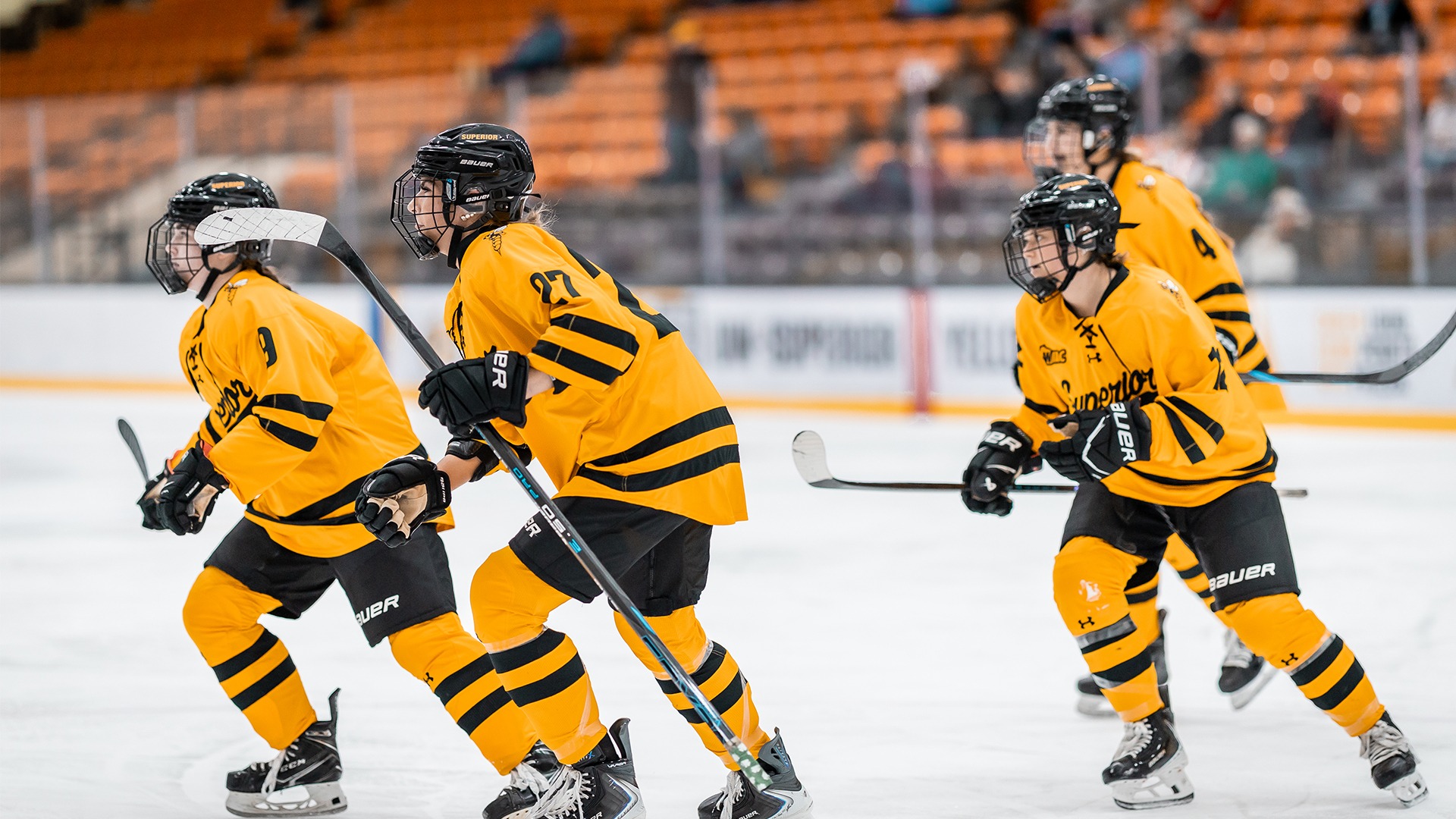 A quartet of Yellowjackets skate back to the bench following a goal.