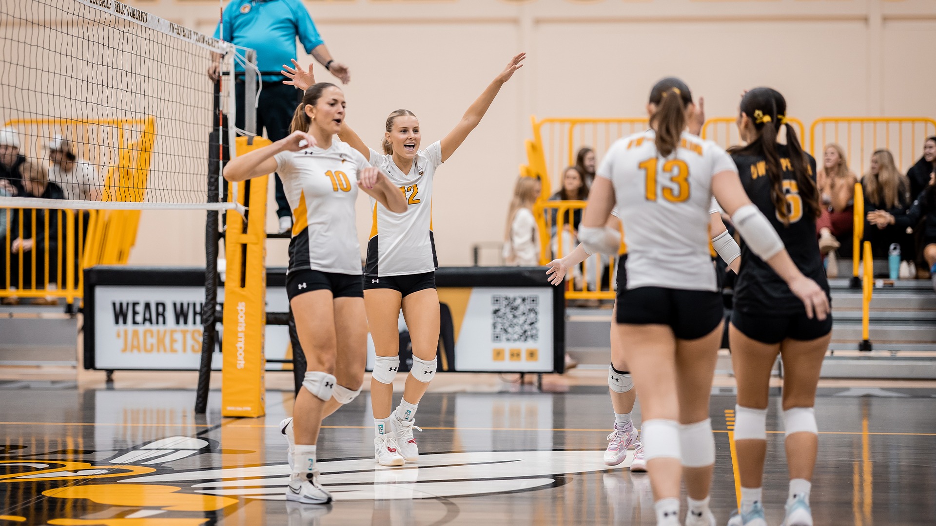 Kate Jamtgaard and her teammates celebrating a point.