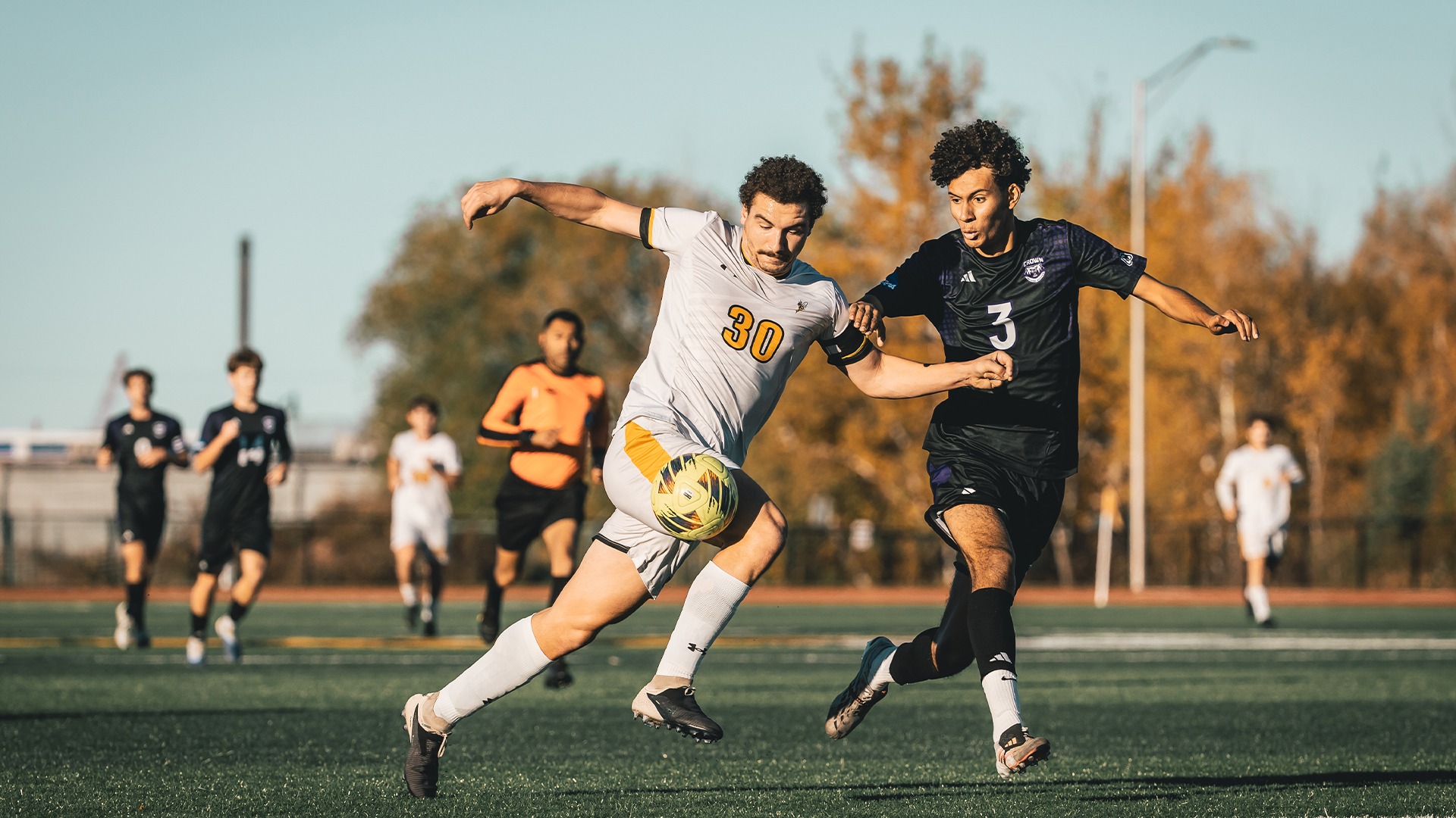 Bryce Boldt moving past a Crown defender with possession of the ball.