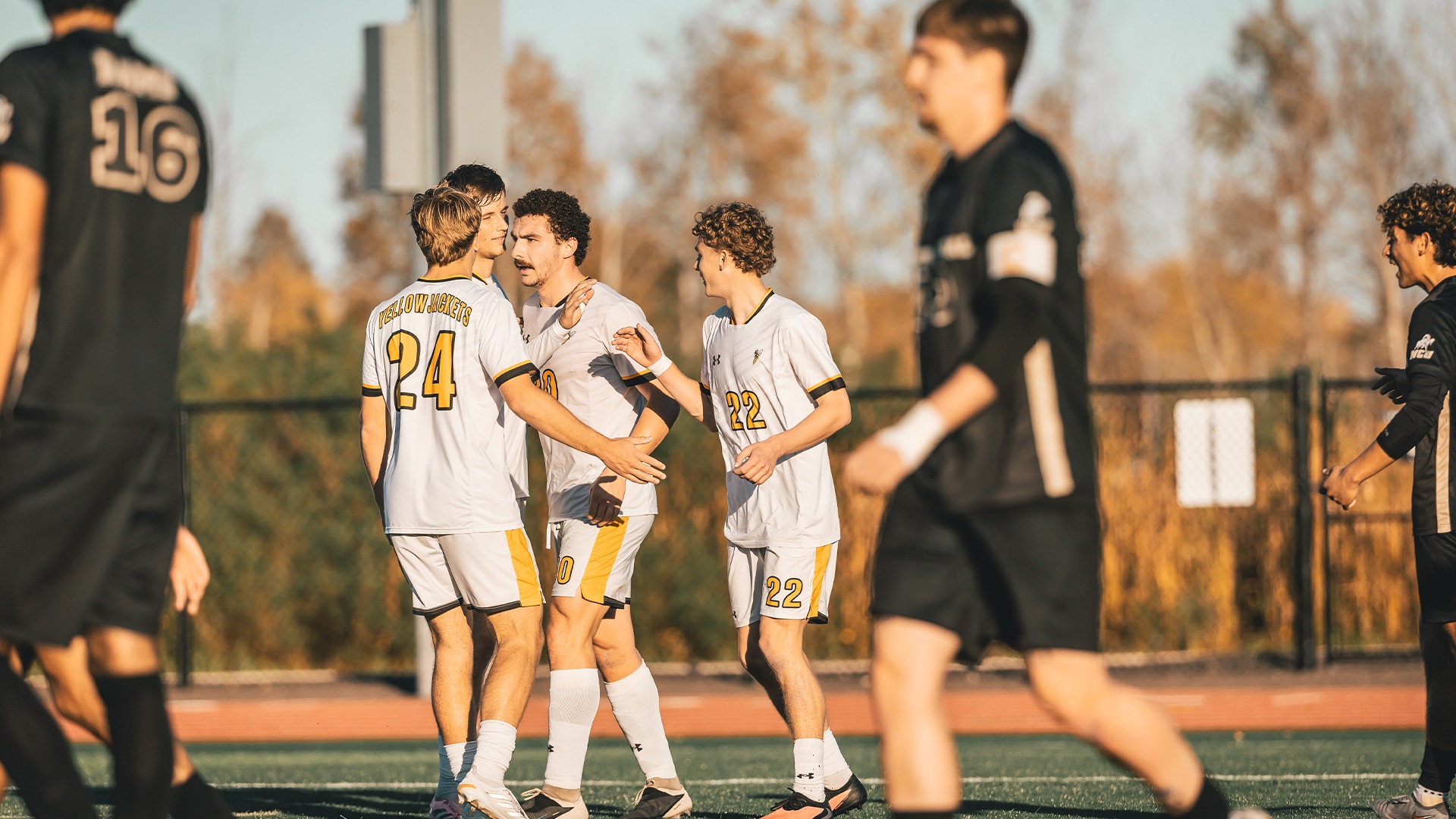 A quartet of Yellowjackets celebrating a goal.