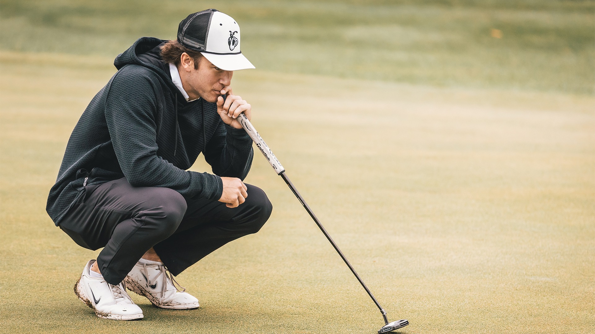 Matthew Unger reading the green before his putt.
