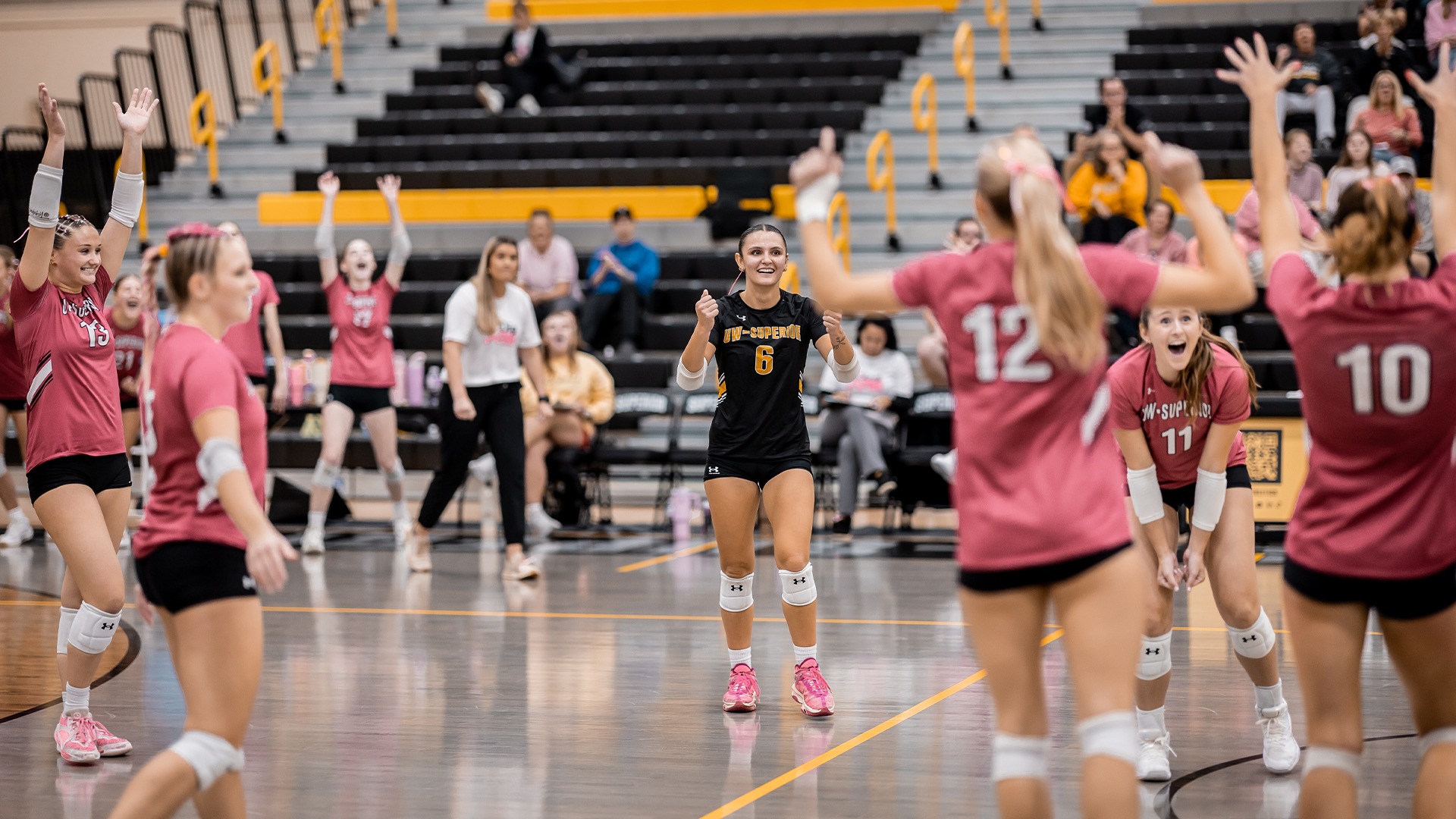 Savanna Hering and her teammates celebrating a point.