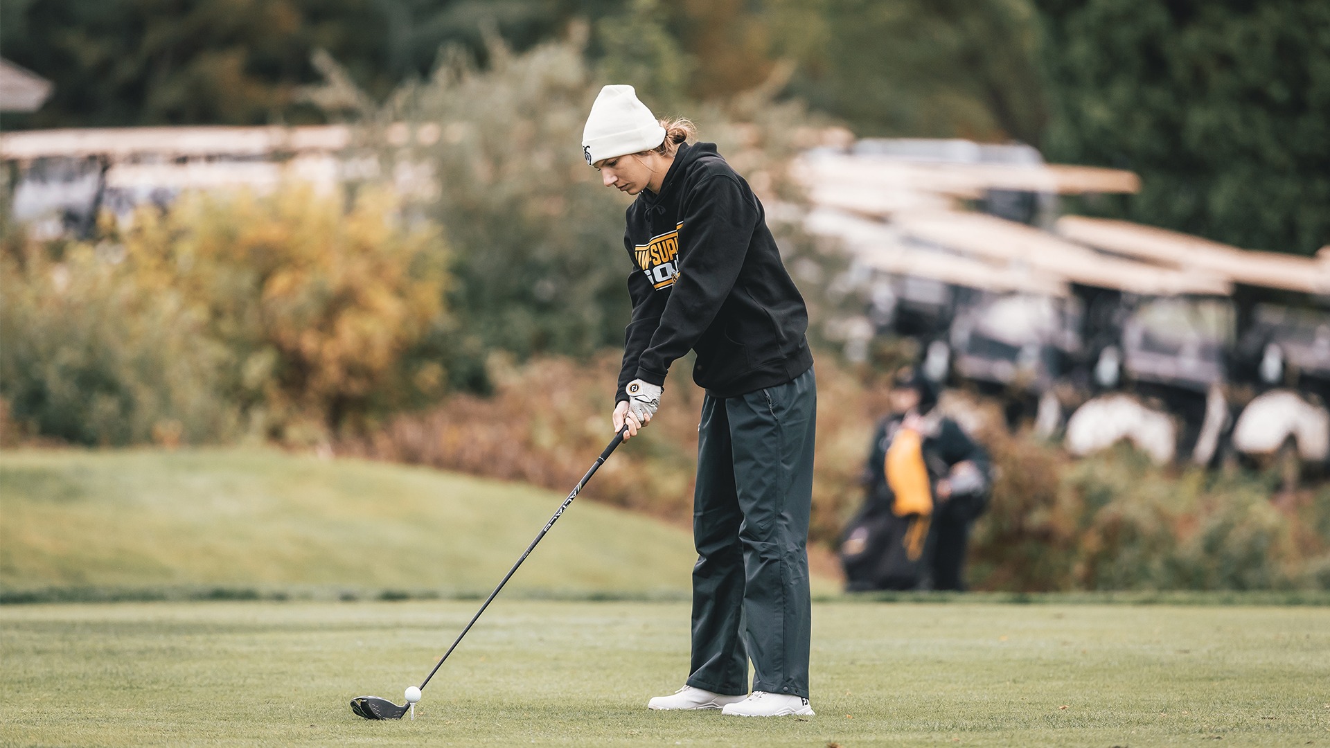Abby Schintz lining up her shot on the tee box.