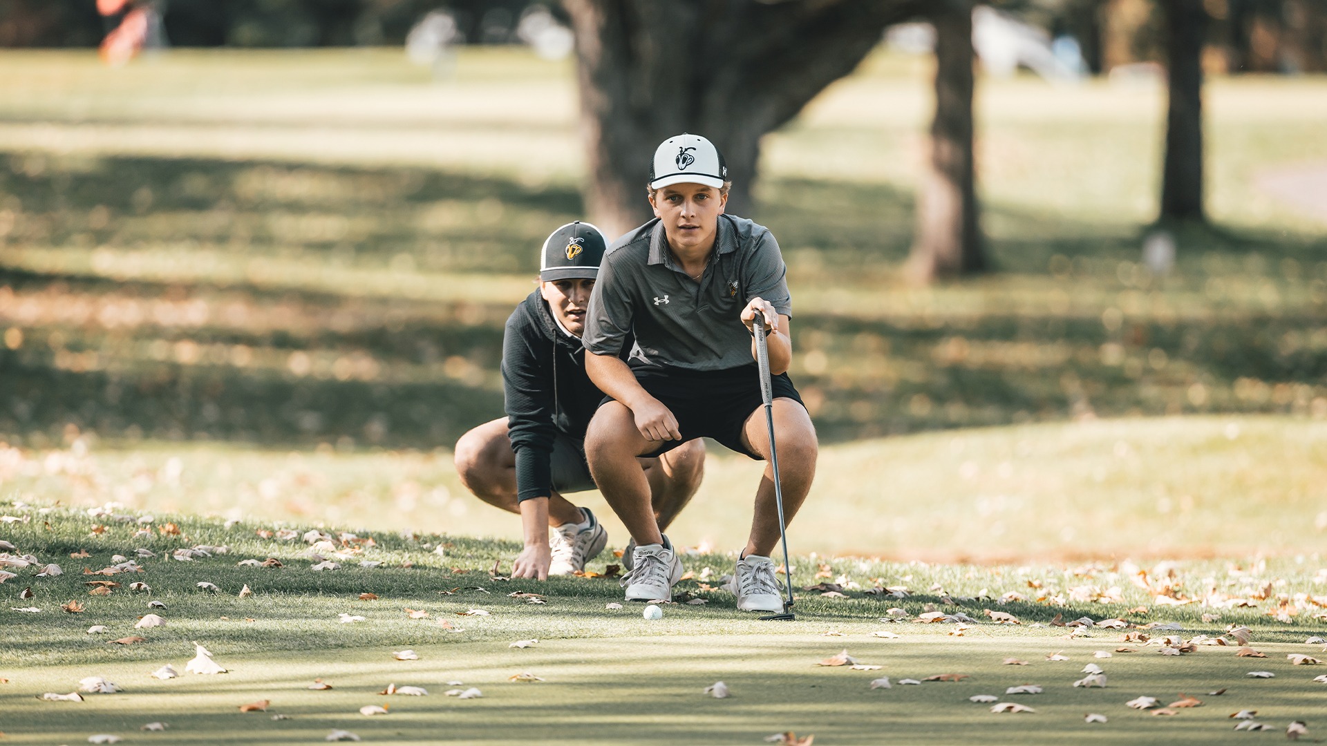 Andrew Slatten and Nate Burke getting a read of the green.