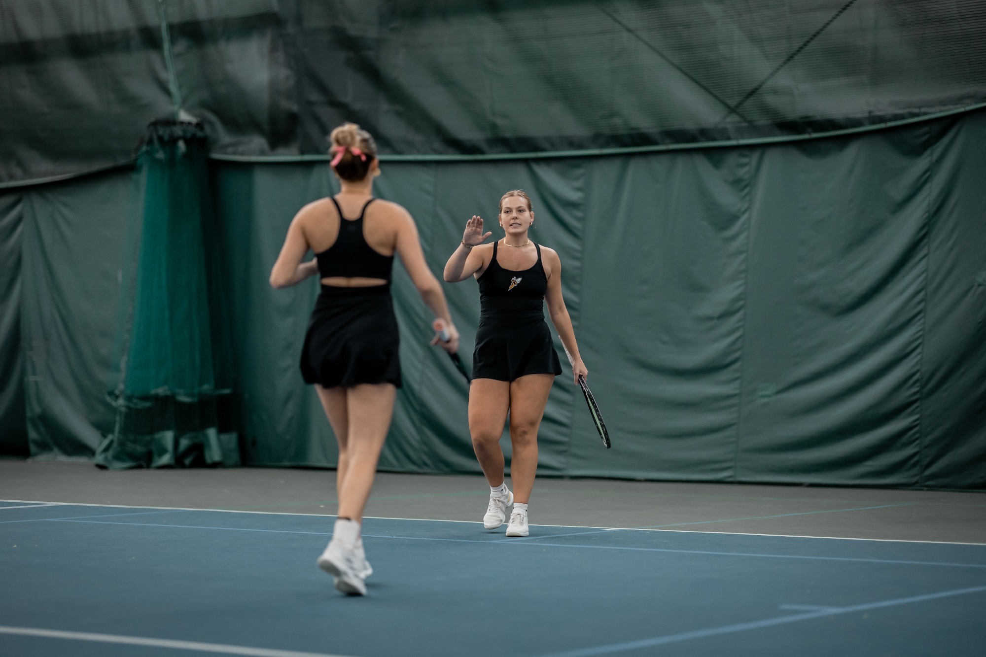 Kate Jonas goes to high five Anouk Bluemm