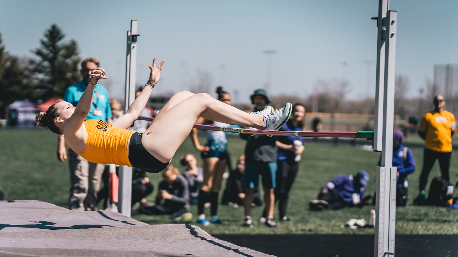 Bel Dimaze leaping over the high jump bar.