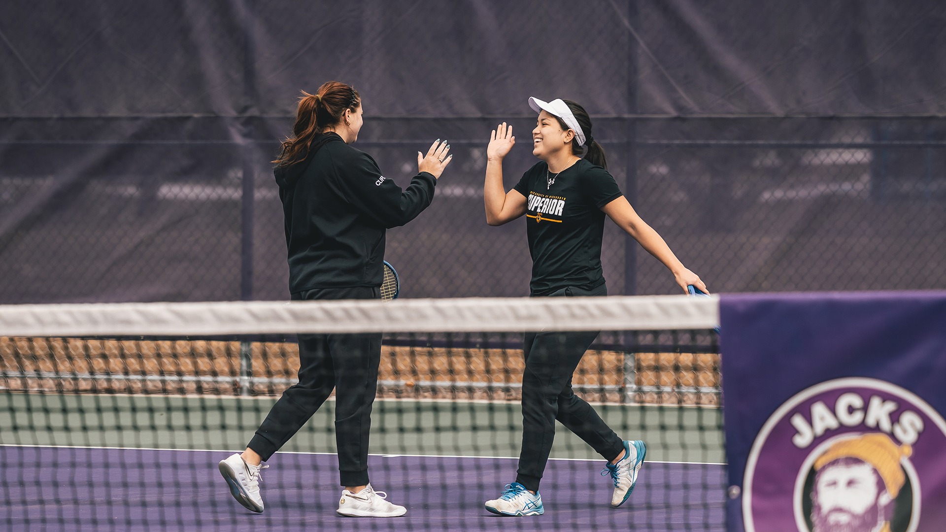 Claudia Curtis and Andreina Tejada high five. 