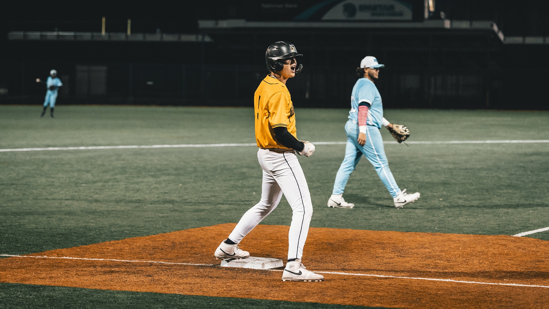 Isaac Johnson celebrating at third base.
