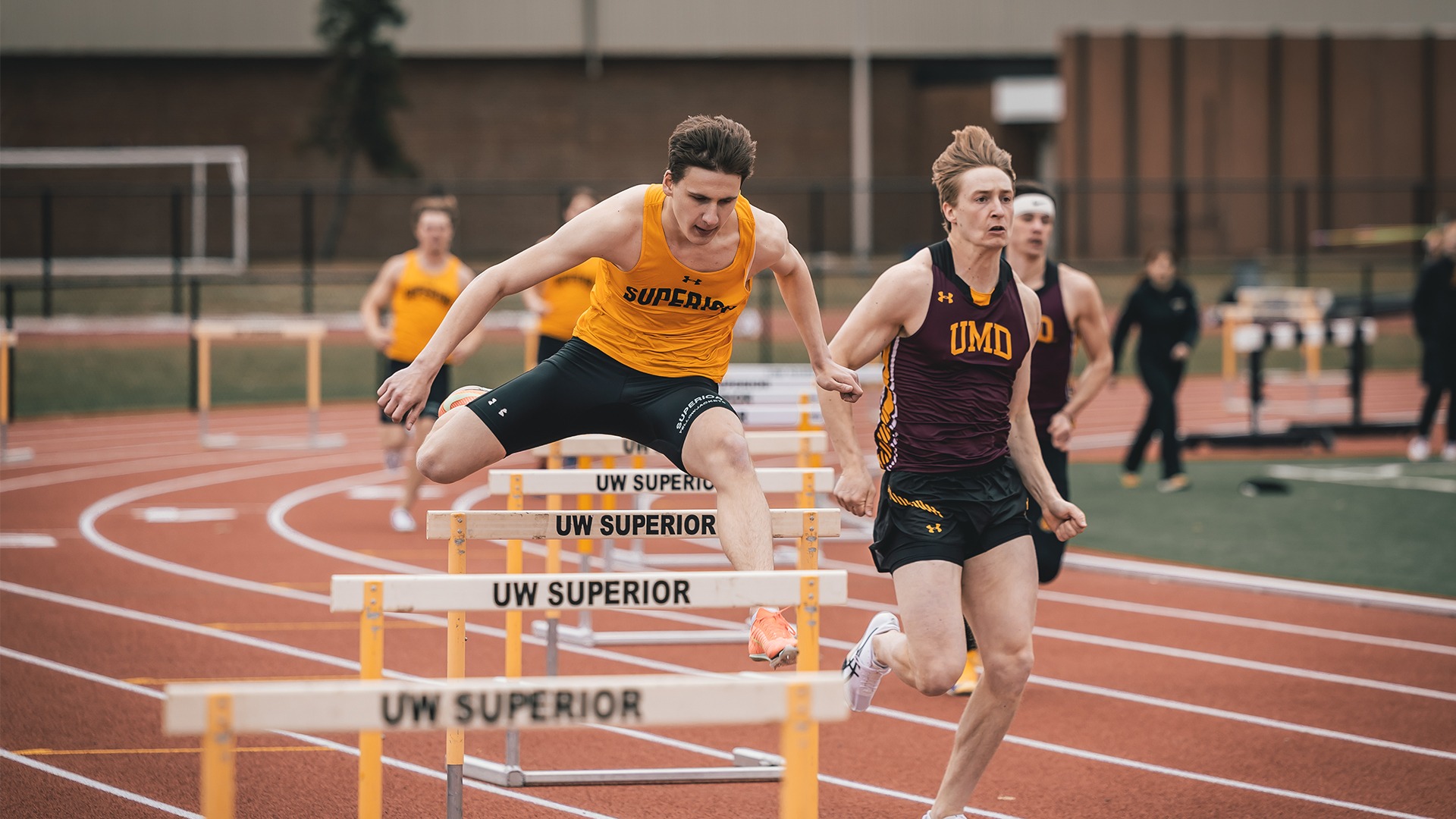 Kyle Peterson leaping over a hurdle.