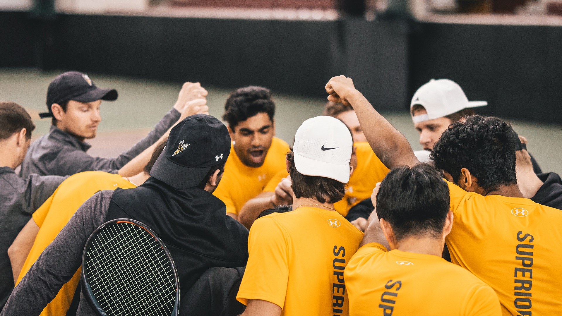 The Yellowjackets huddling before their match. 