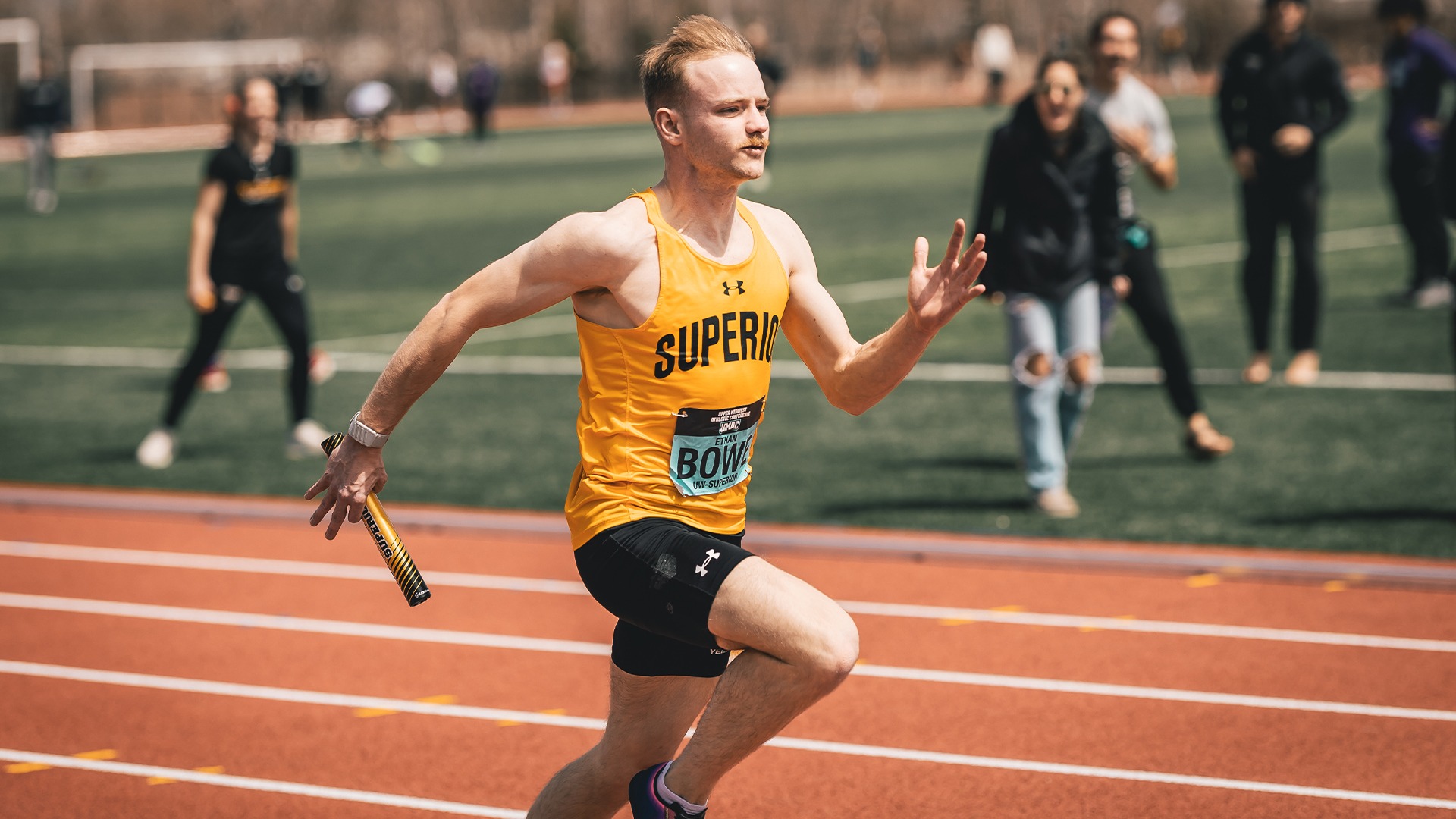 Ethan Bowe running a relay.