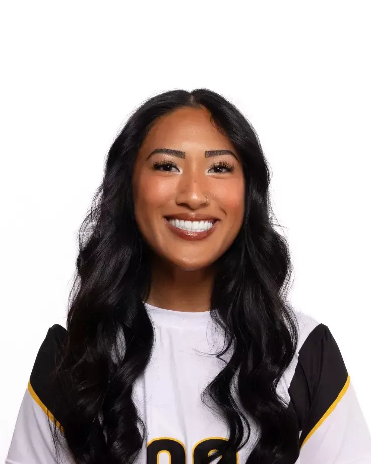 A headshot of a woman in a white jersey