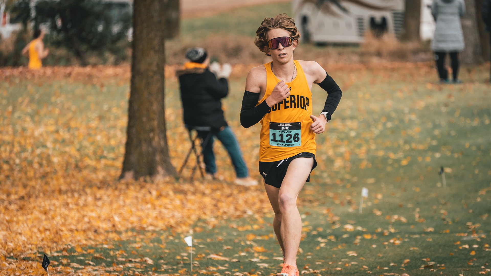 Maverick Hoogland running on the cross country course with glasses on.