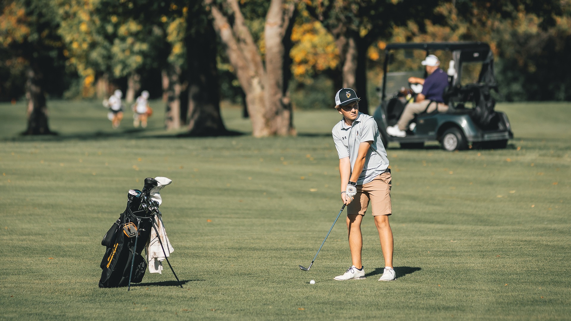 Andrew Slatten preparing to make a golf shot in the fairway.