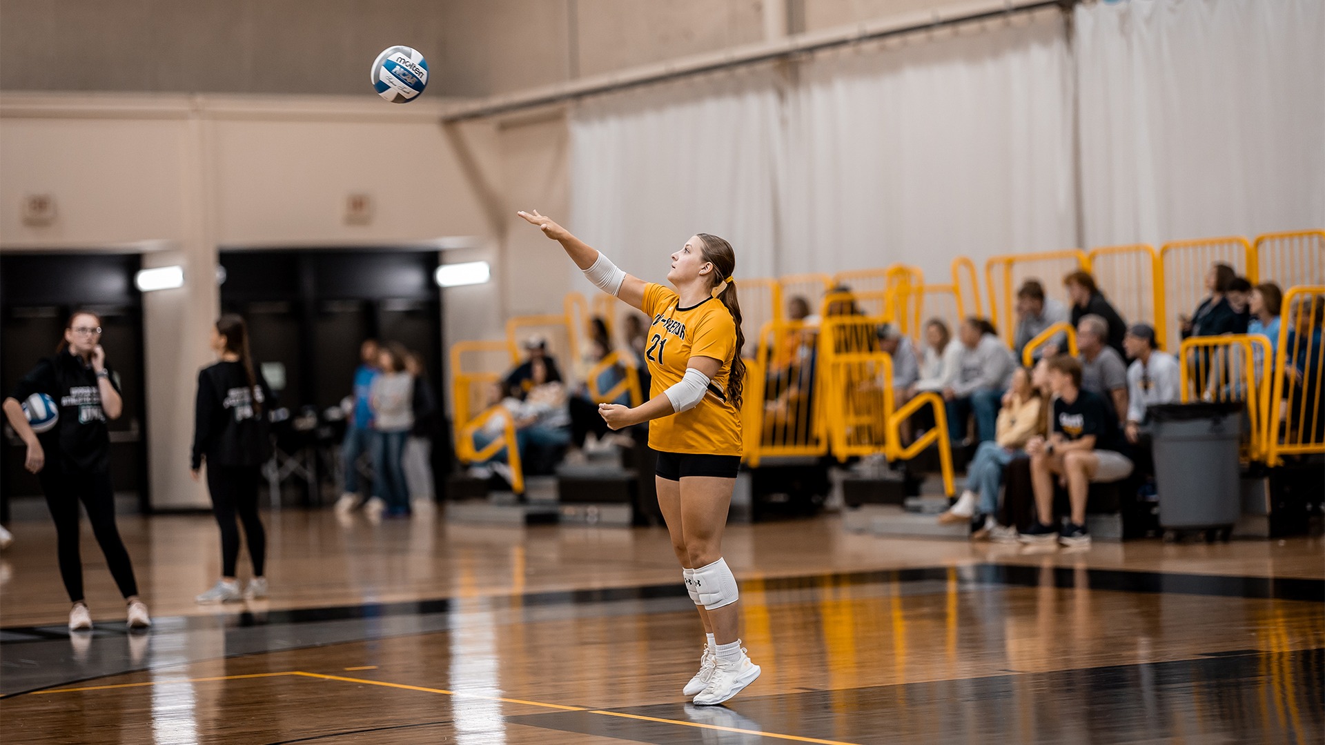 Alaina Wilberg after making contact with a serve.