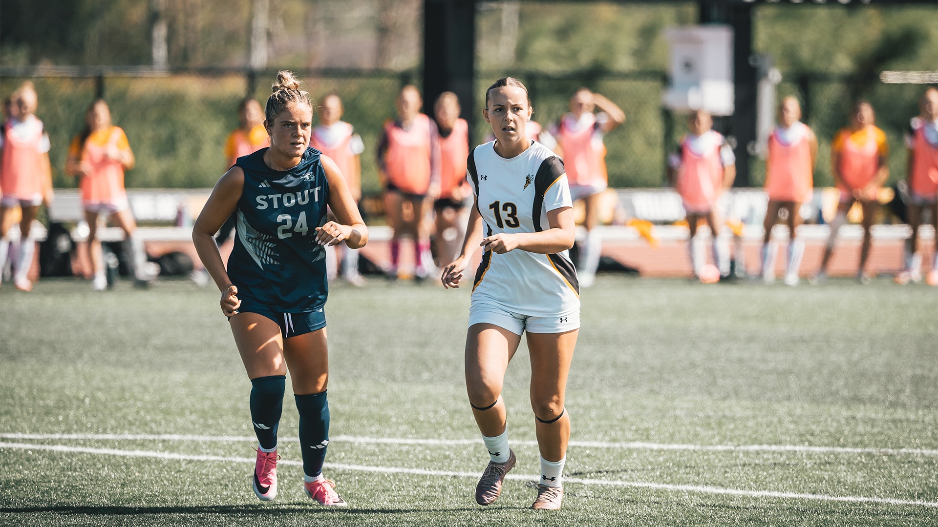 Reese Brekke watching play develop next to a UW-Stout defender.