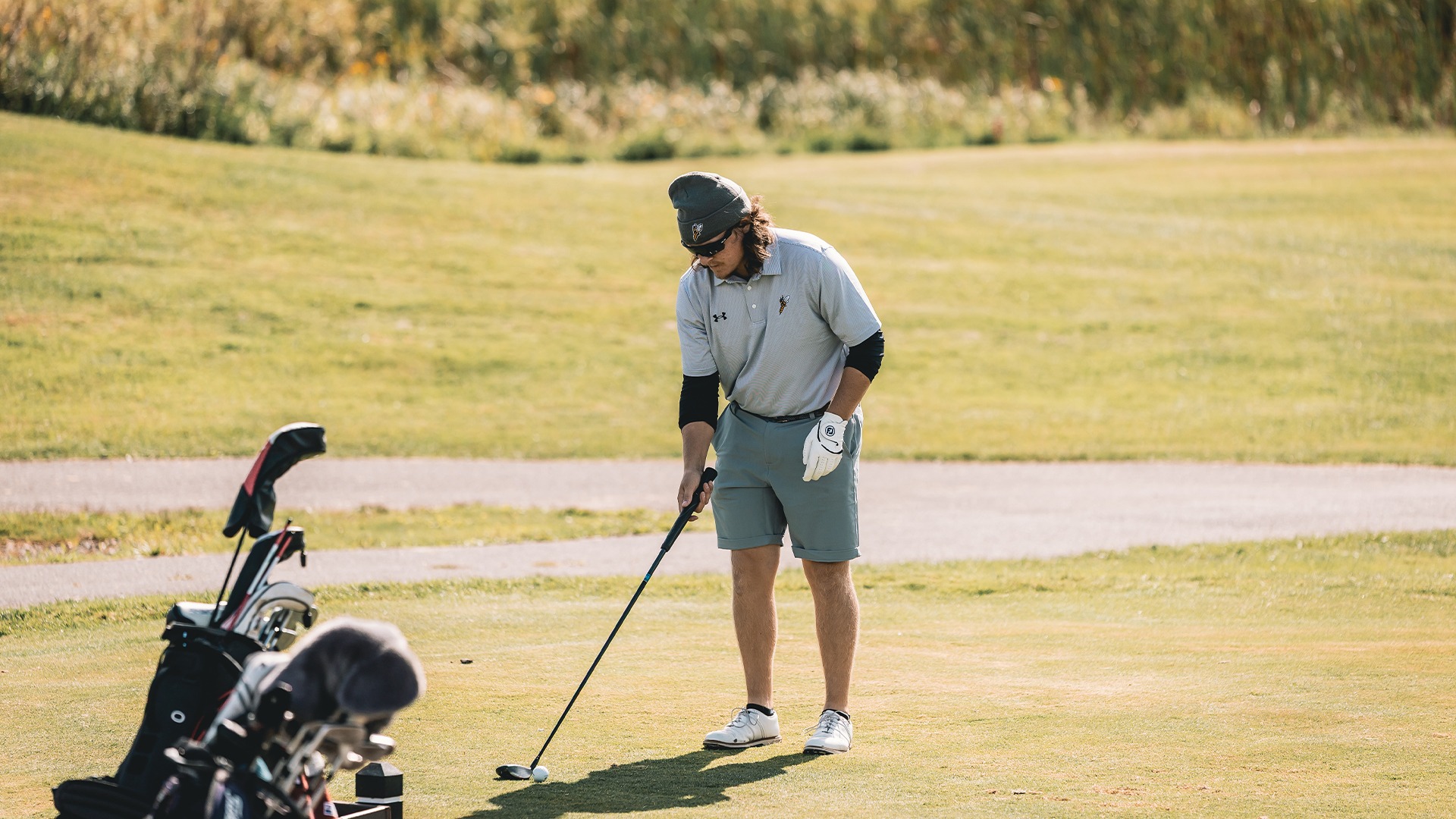 Jamin Durfee approaches his ball before making a golf shot.