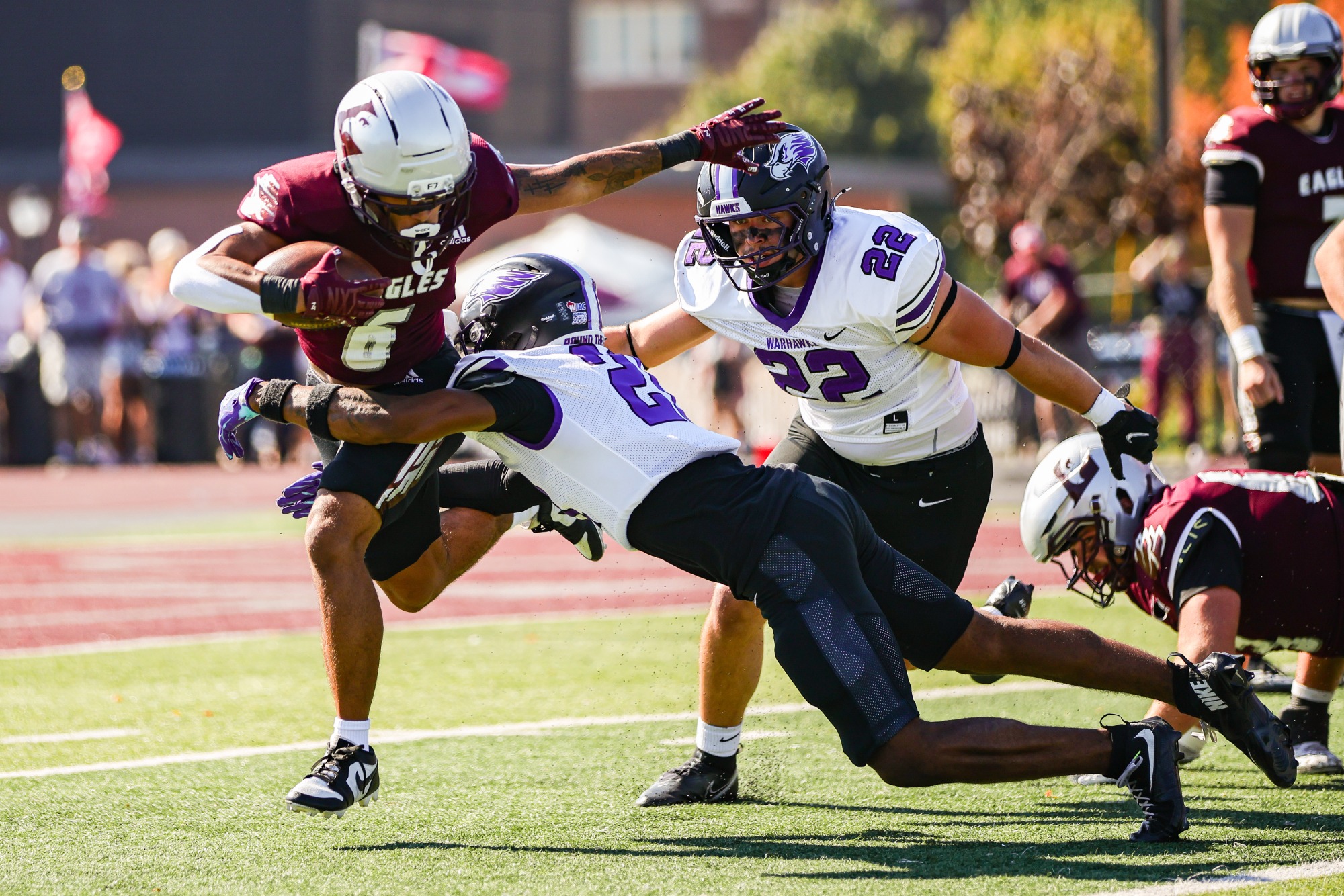 AJ Johnson and Chase Matthias tackle a UWL ball carrier