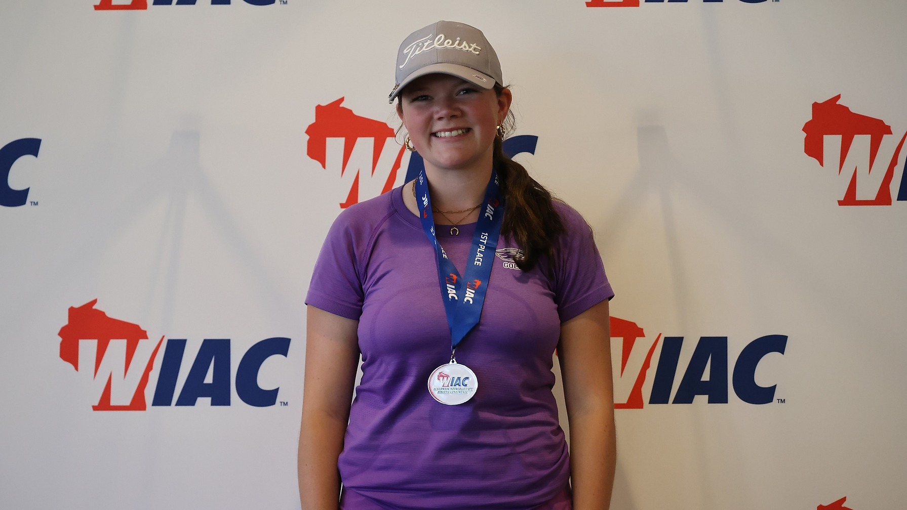 Delainey Halverson poses with medal after winning WIAC Individual Title