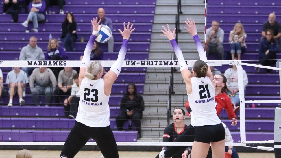 Abbie Dix and Aubrie Krzus go up for a block