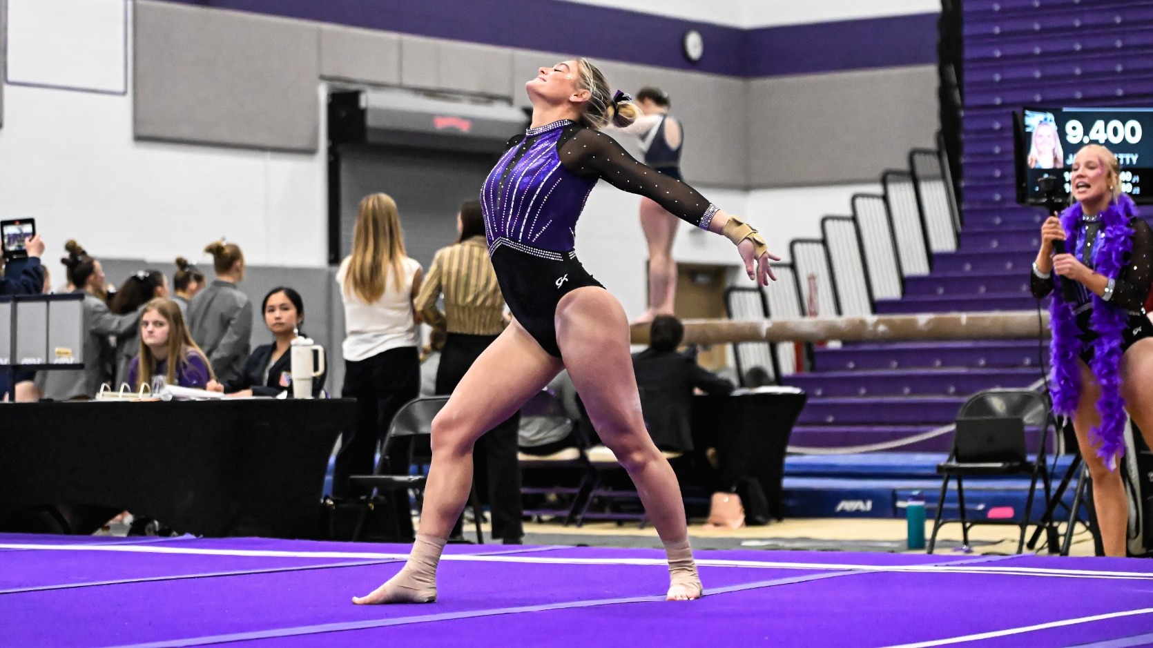 Elaine Copeland competes on the floor during a home dual