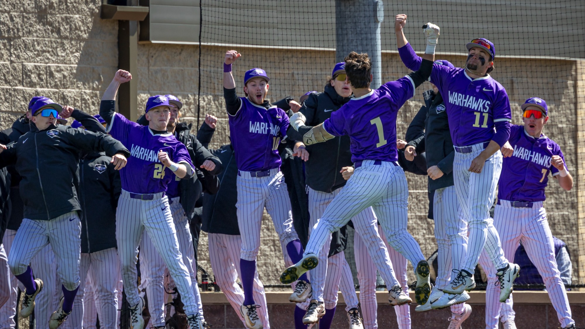 Baseball team celebrating after Olson's Home Run