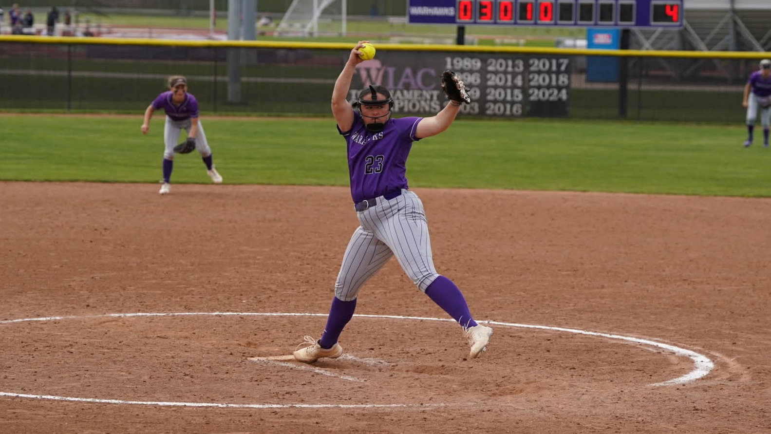 Madi DeBennette pitching against Elmhurst