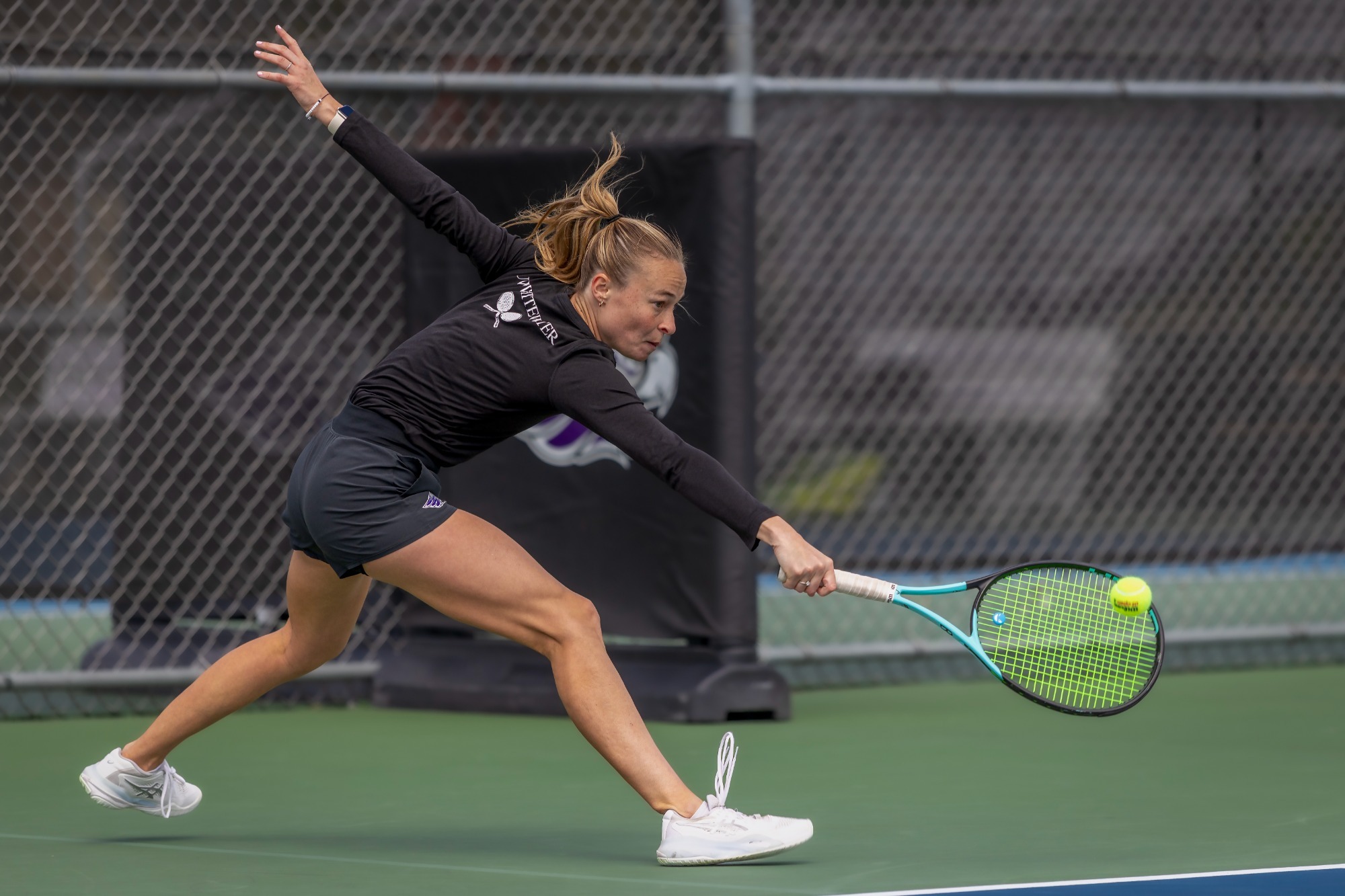 Molly Asfeld reaches for backhand hit
