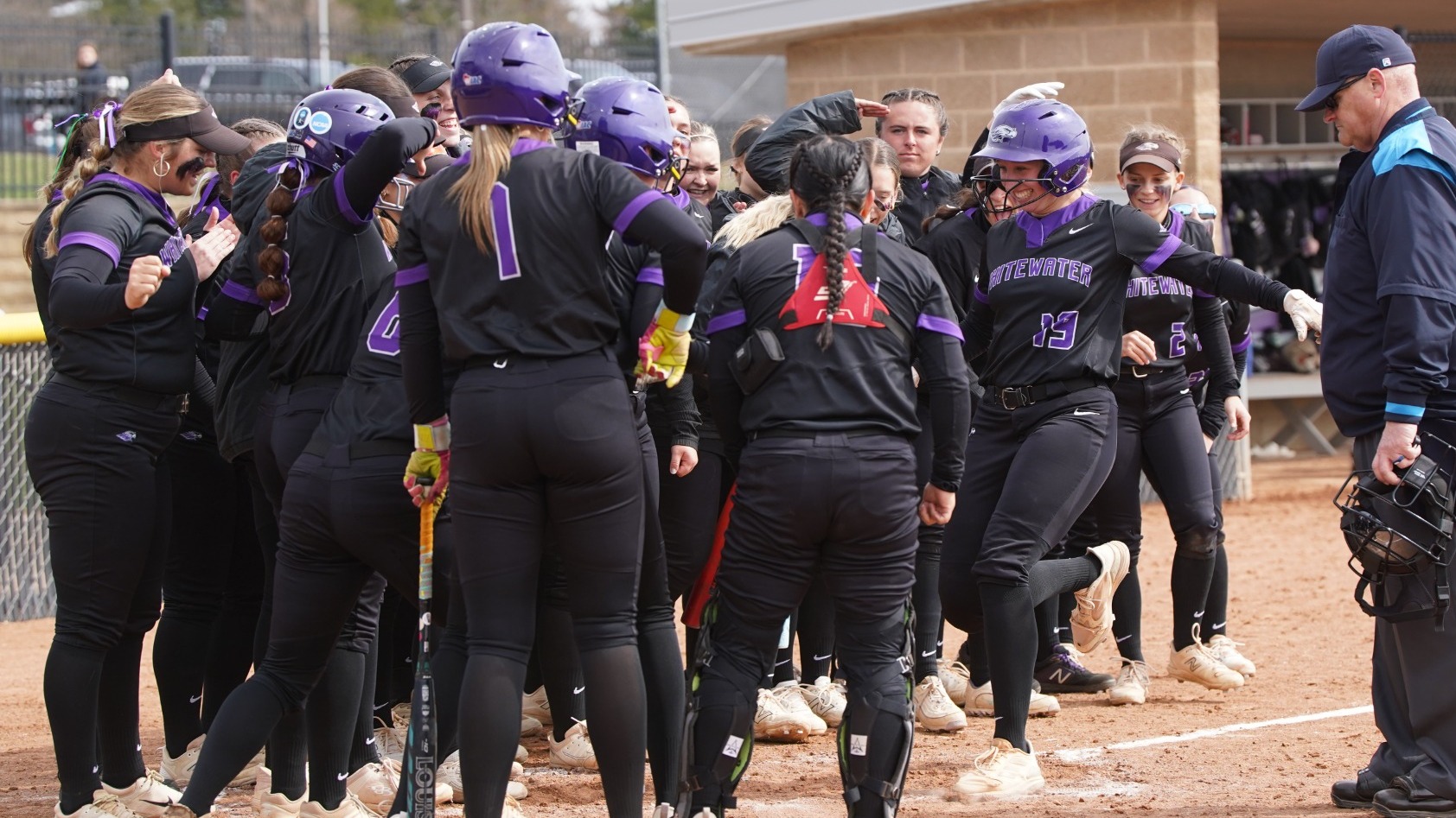 Rachel Radish touches the plate after hitting a homerun against Carroll