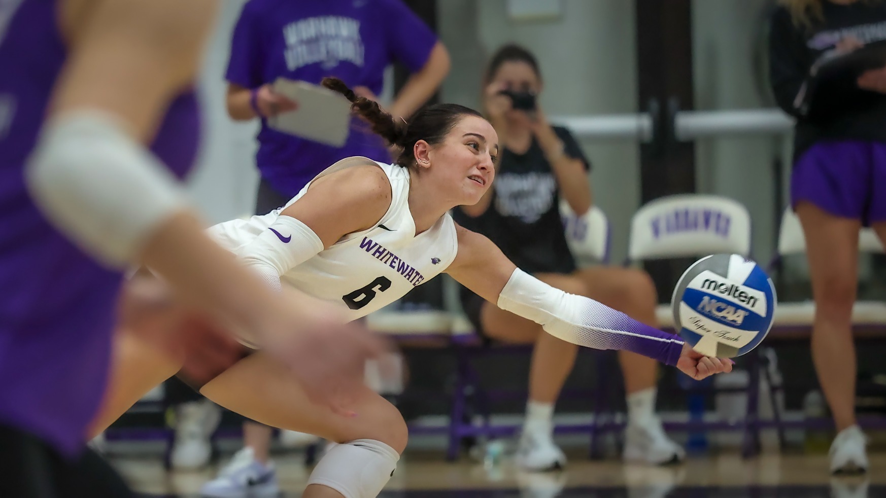 Natalie Lawton one hands a dig against CUW