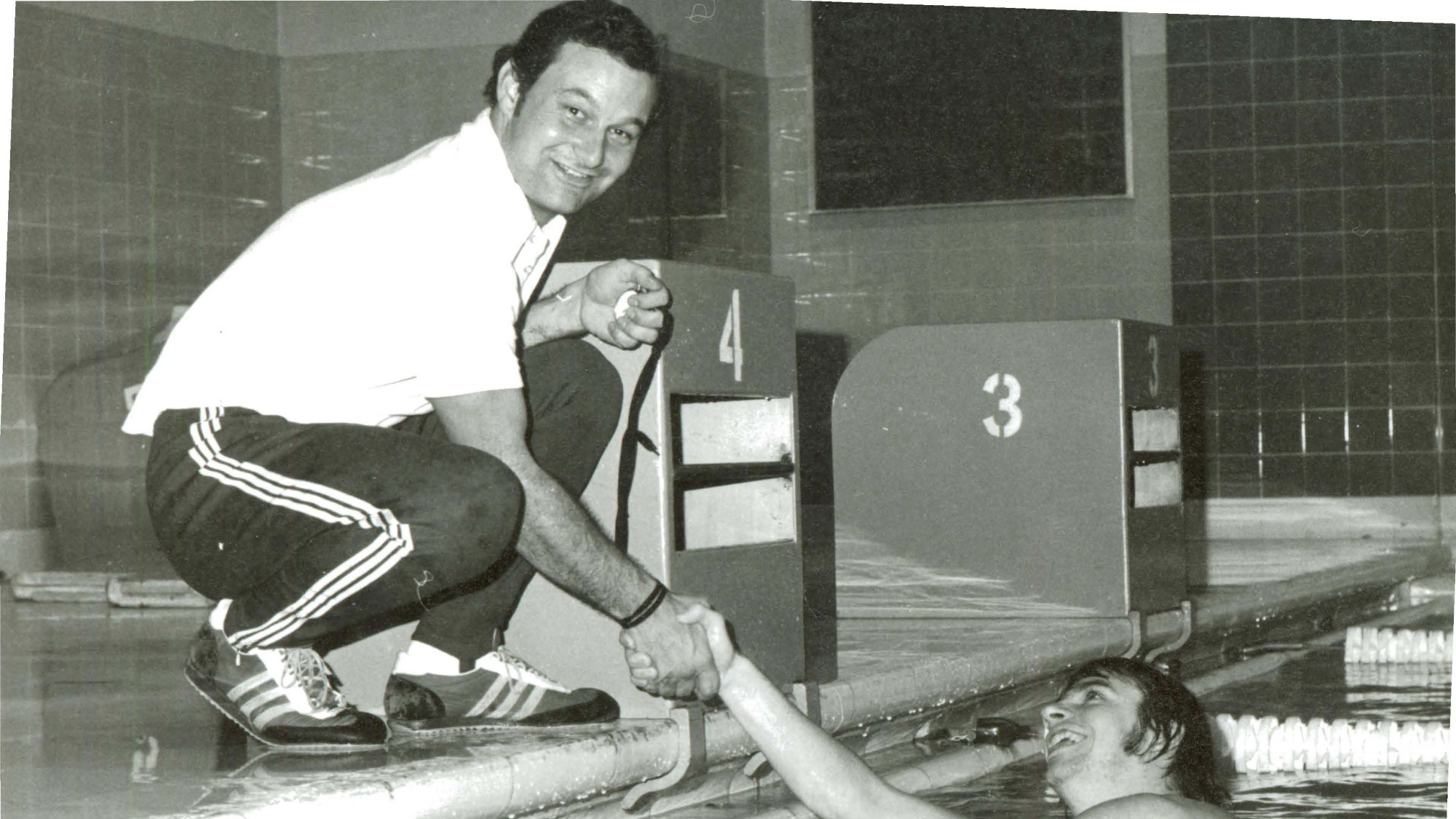 Robin Campbell coaching swimming at the side of the pool