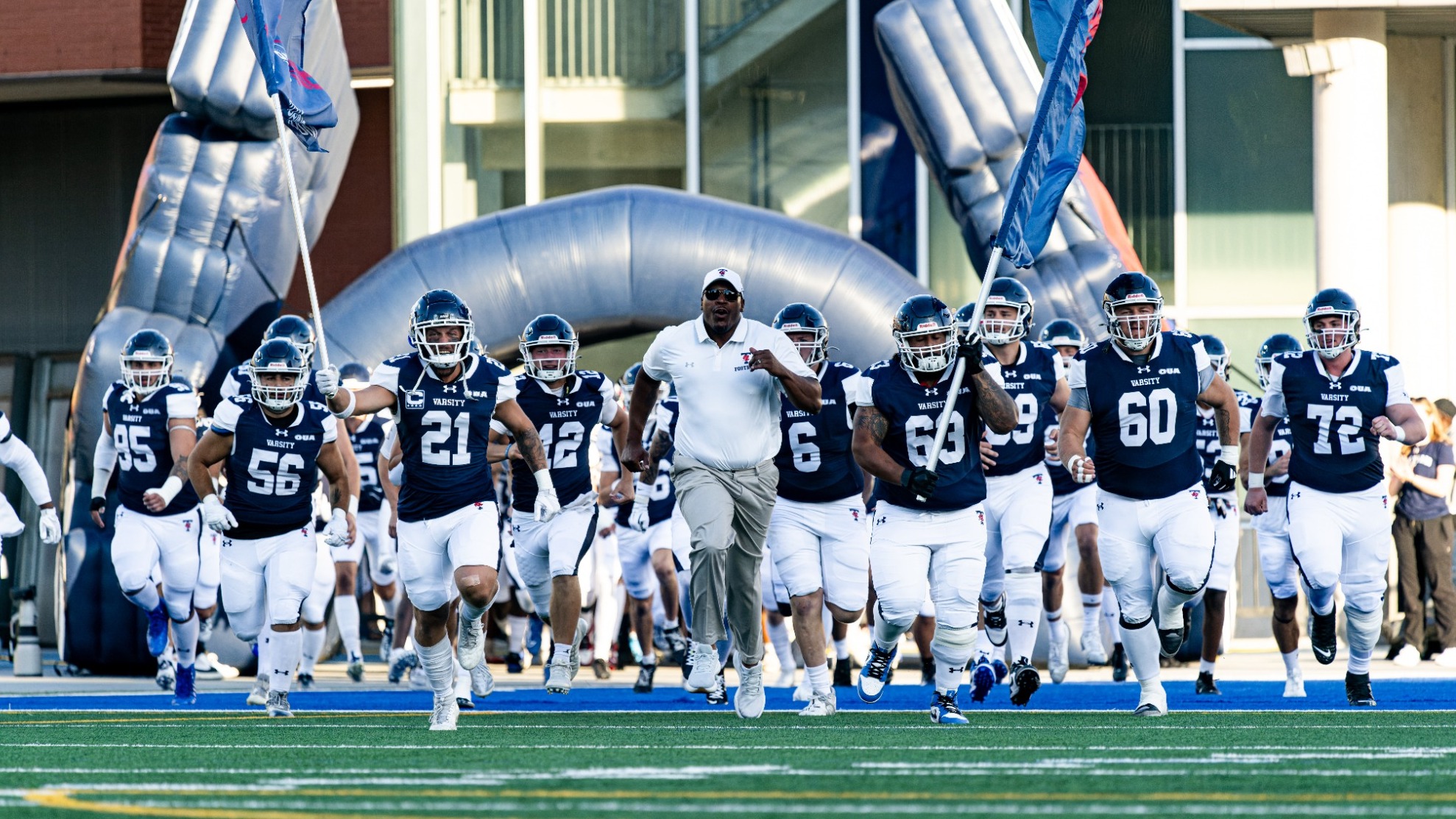 Football team running through the tunnel onto the field