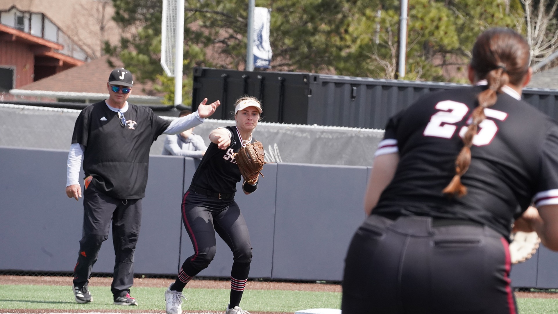 Alyssa DePoorter makes a throw to first baseman Logan Gronberg.