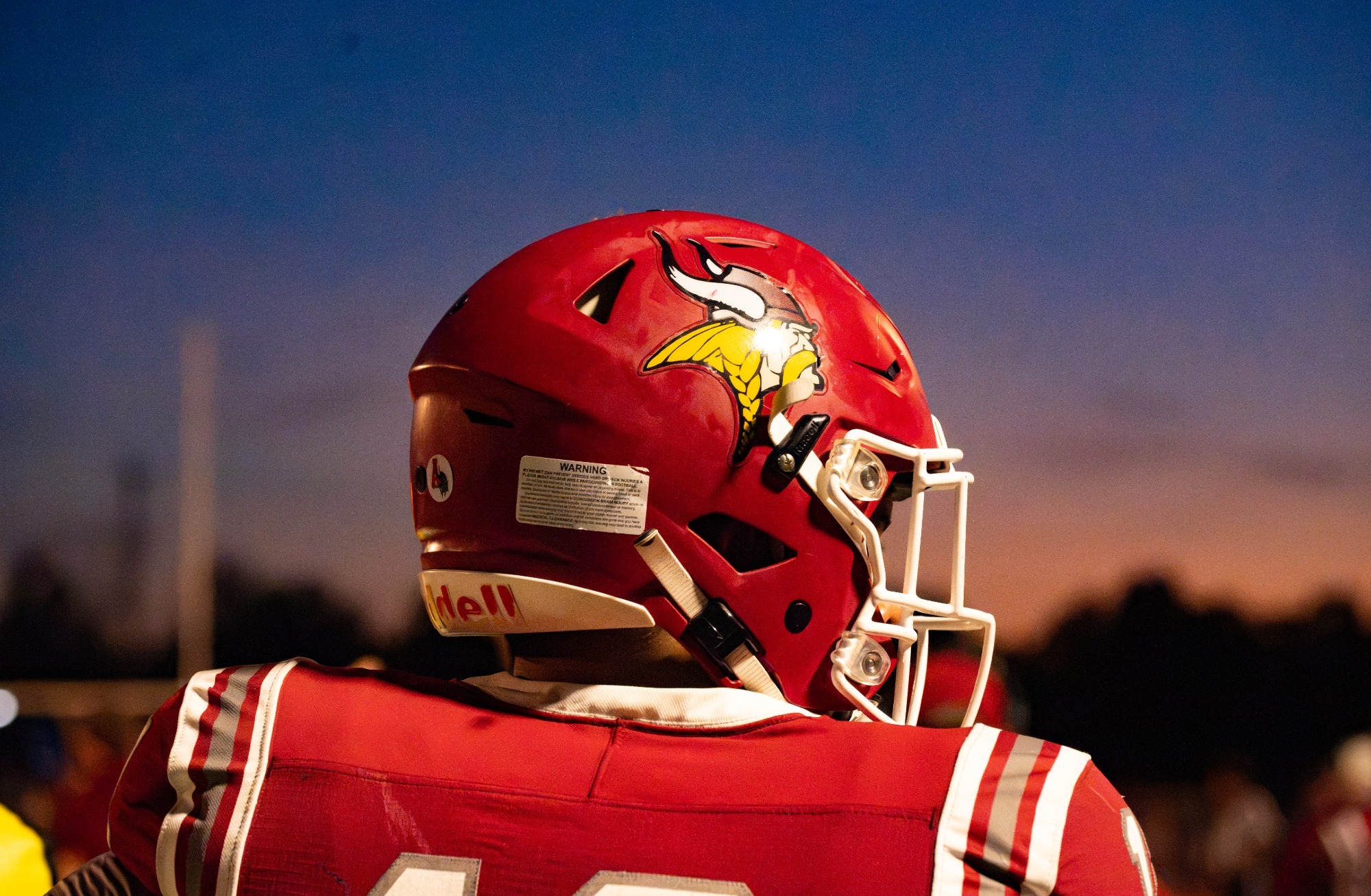Post-game story- Fb vs Dickinson St Part 2 2026, VCSU player looks into the distance as the sun sets in Valley City.